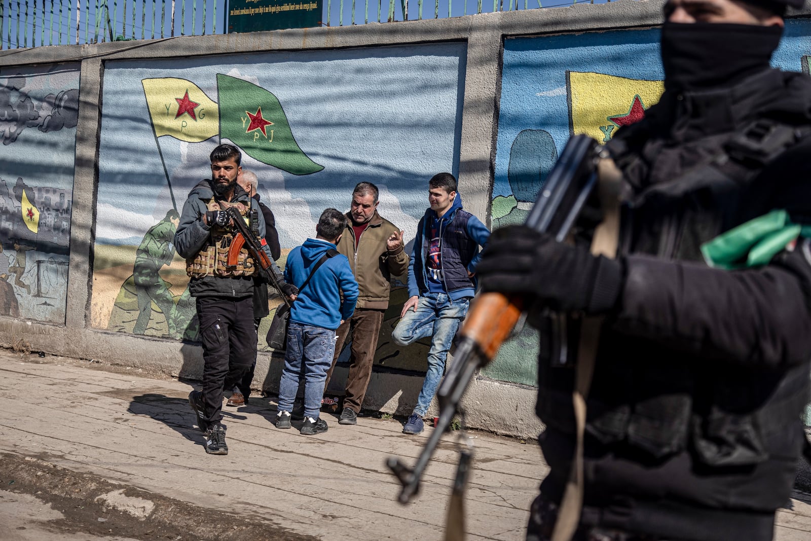 Syrian Democratic Forces (SDF) fighters patrol the area during a demonstration to demand the release of Kurdish leader Abdullah Ocalan in Qamishli, northeastern Syria, Saturday Feb. 15, 2025.(AP Photo/Baderkhan Ahmad)