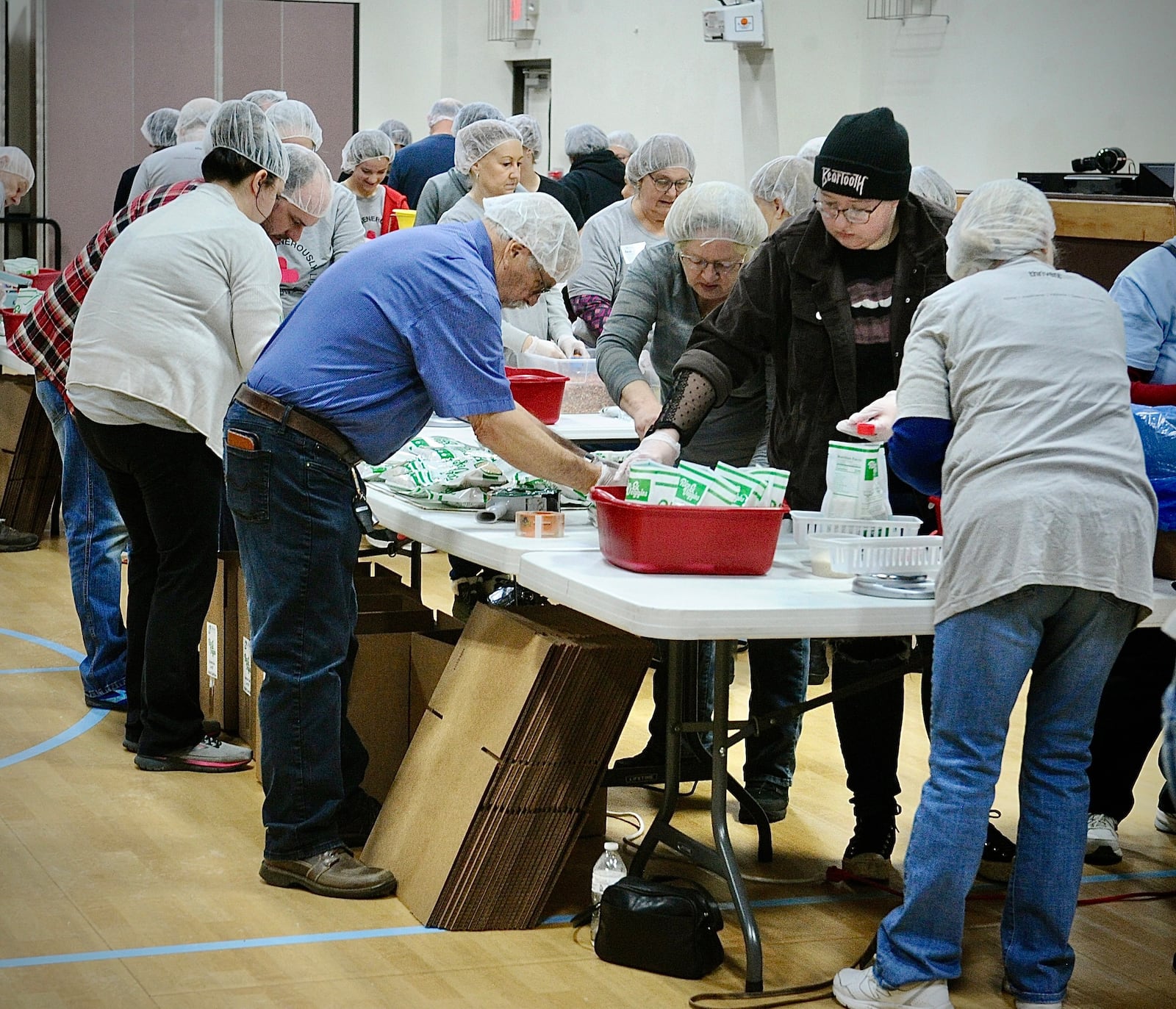 Over 140 volunteers from ages of 3 to 85 years old, packed over 35,640 meals Saturday, Jan. 20, 2024 for third world countries at the Abiding Christ Church in Fairborn. MARSHALL GORBY\STAFF