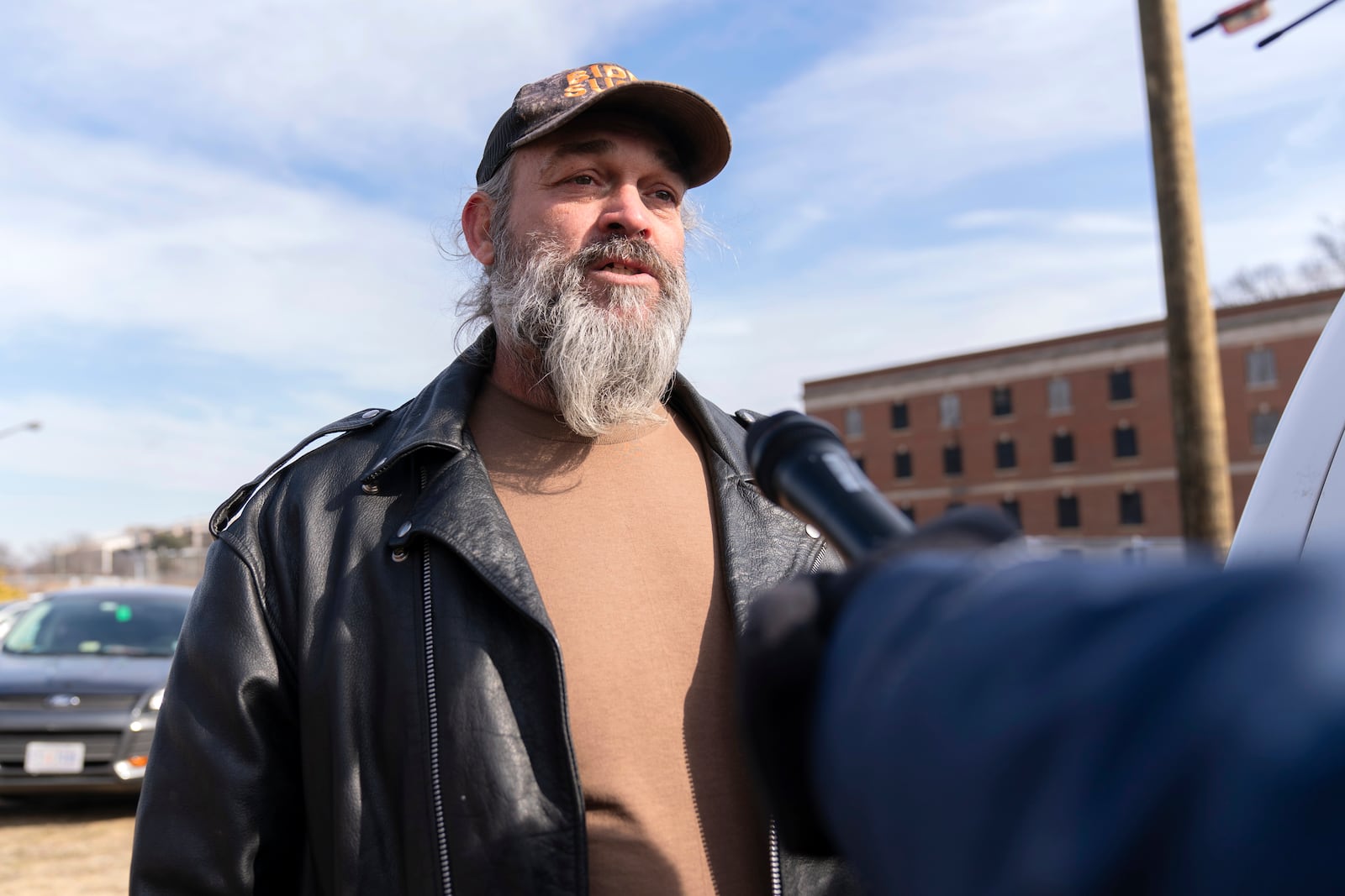 Supporter of President Donald Trump, William Sarsfield III, who was convicted for participating in the Jan. 6 riot at the U.S. Capitol, talks to reporters after being pardoned and released in the early morning hours from the Philadelphia Federal Detention Center before traveling to Washington, Tuesday, Jan. 21, 2025. (AP Photo/Jose Luis Magana)