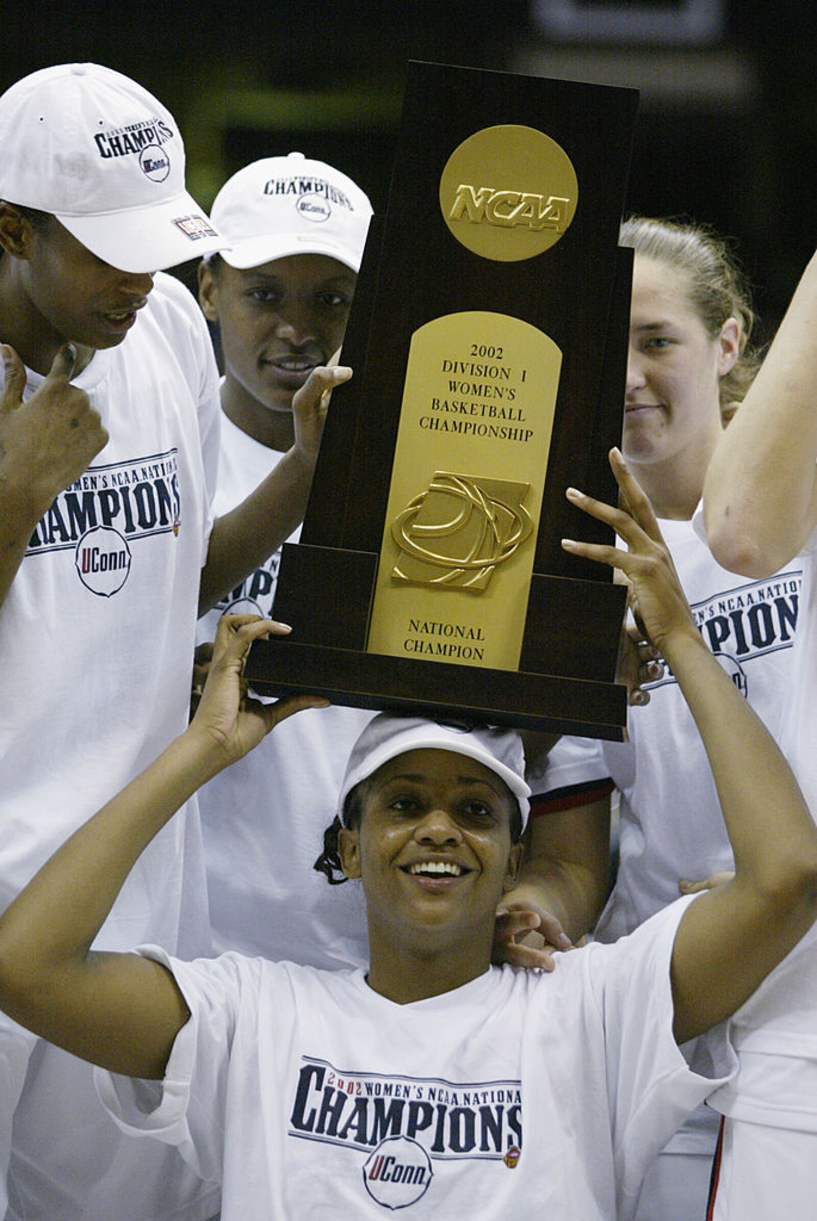 31 Mar 2002: Tamika Williams #34 of Connecticut holds up the trophy after beating Oklahoma in the NCAA Women's Championship Game at the Alamo Dome in San Antonio,Texas. Connecticut won 82-70 to finish their season undefeated. DIGITAL IMAGE. Mandatory Credit: Andy Lyons/Getty Images