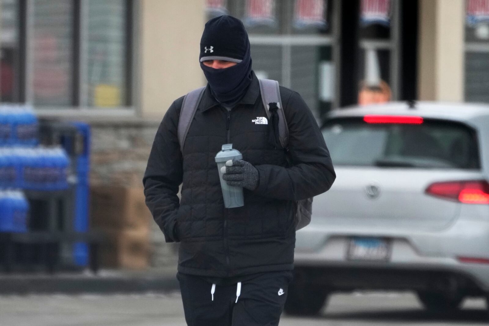 A pedestrian bundles up as he walks on the street during cold weather in Chicago, Wednesday, Jan. 8, 2025. (AP Photo/Nam Y. Huh)