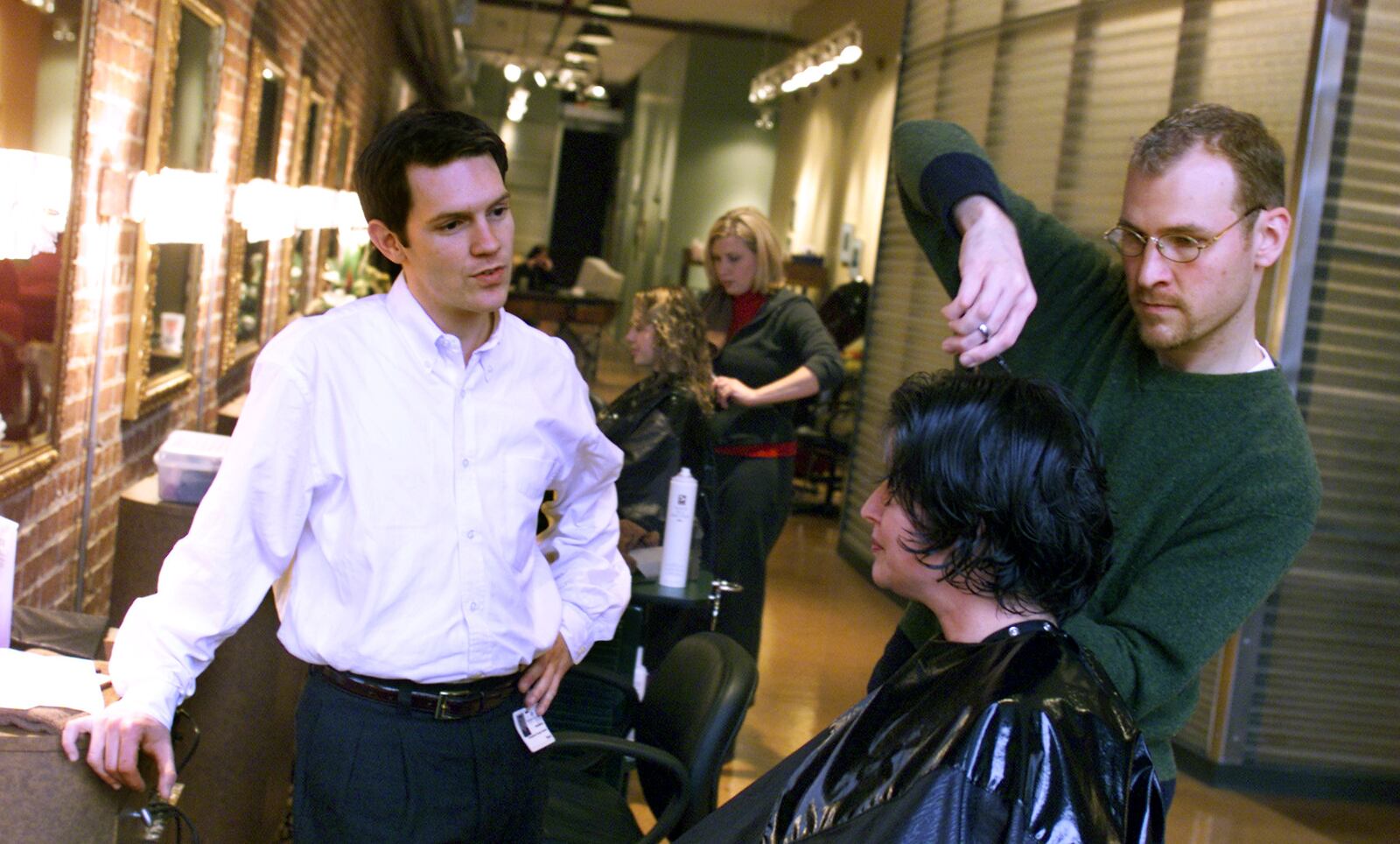 Archived 1999 photo: The Cannery has a new hair salon called the Square One Salon and Spa.  Mindy Esmon has her hair cut by one of the owners, Doug Henderson while Brent Johnson (L) looks on.  The shop has been open for about five weeks now.