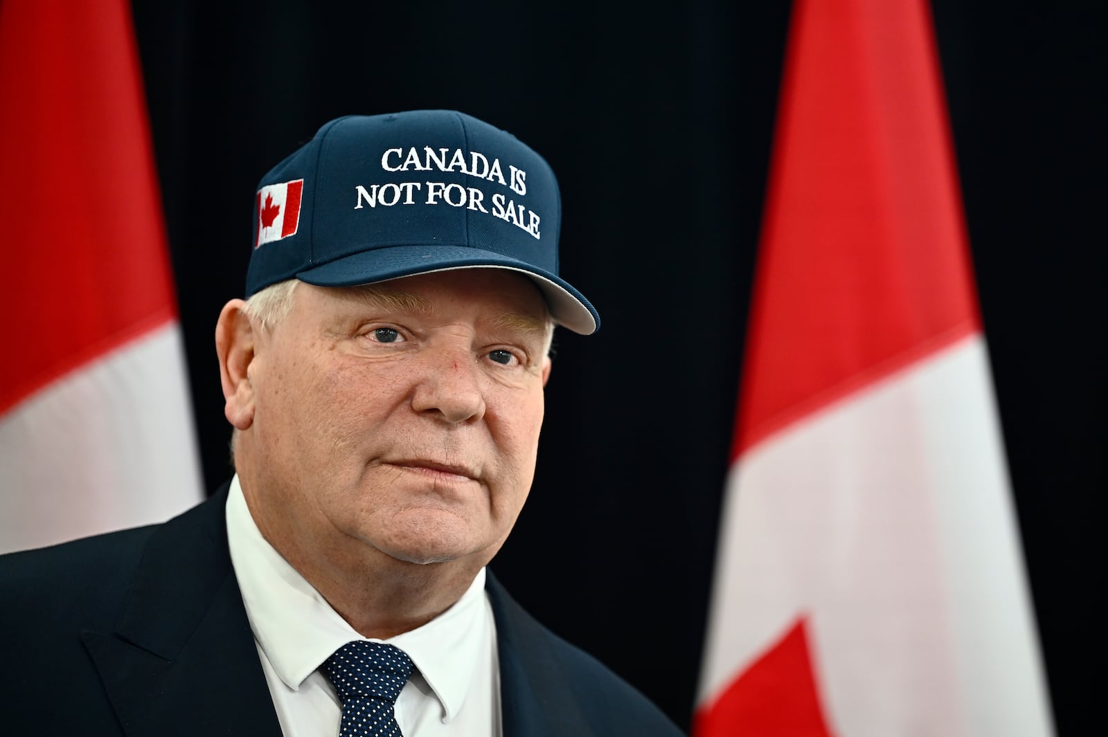 Ontario Premier Doug Ford, wearing a 'Canada Is Not For Sale' hat, speaks as he arrives for a first ministers meeting in Ottawa on Wednesday, Jan. 15, 2025. (Justin Tang/The Canadian Press via AP)