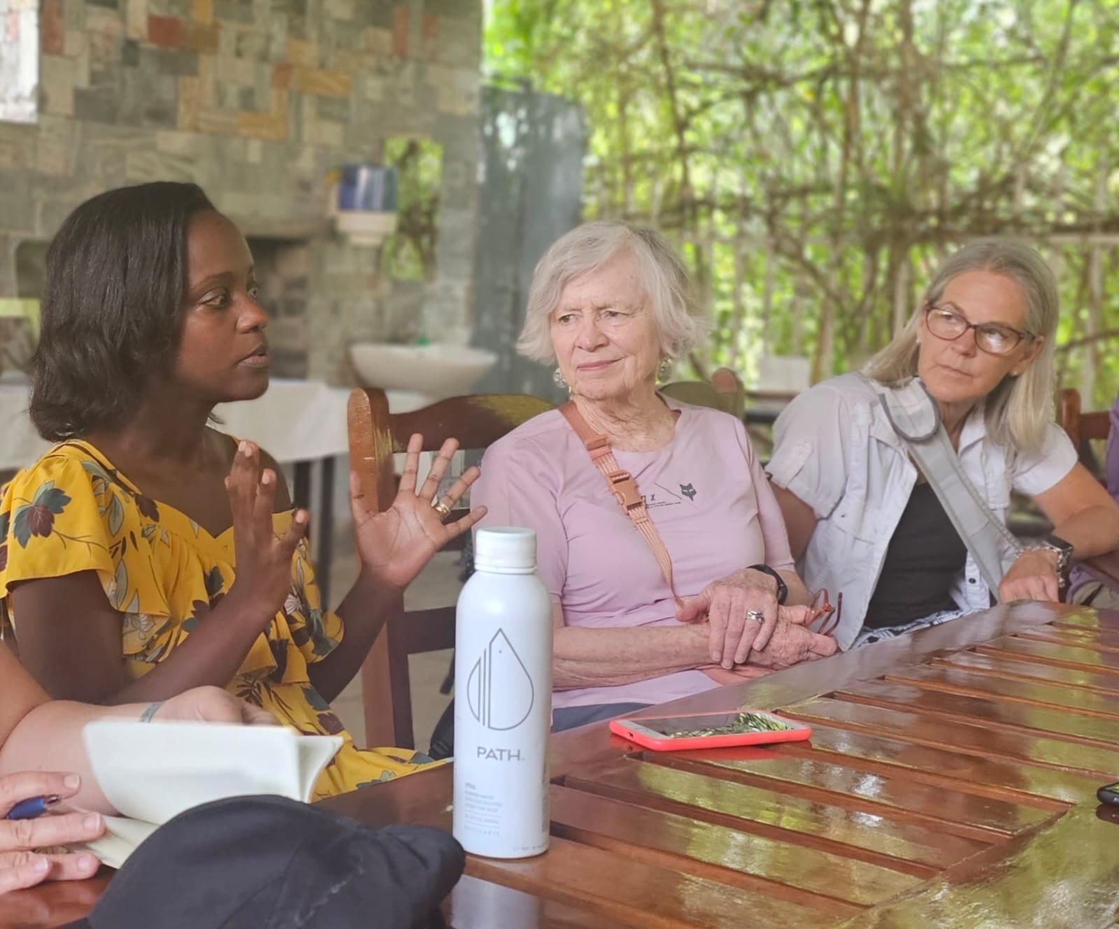 Bridget Federspiel (far right), who teaches history at Stivers School for the Arts, listens to a survivor of genocide during a trip to Rwanda. COURTESY OF BRIDGET FEDERSPIEL