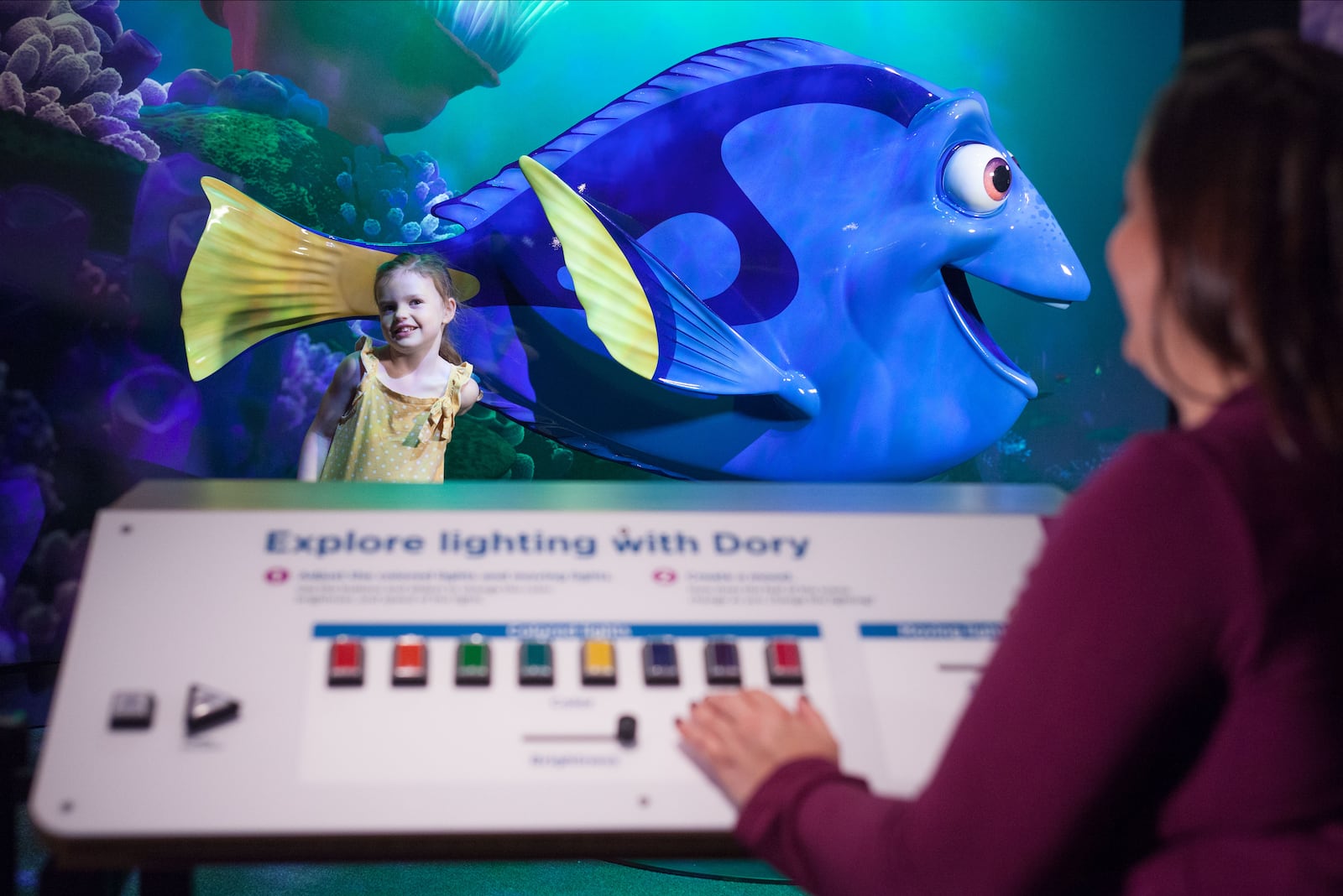 Visitors adjust the lighting for their photo with Dory. CONTRIBUTED