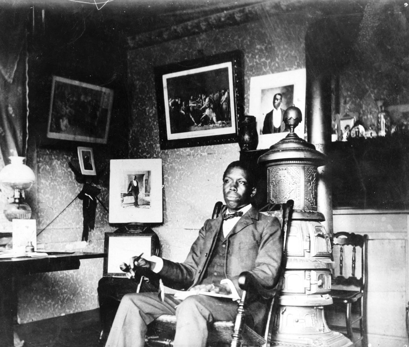 A portrait of Paul Laurence Dunbar seated in a rocking chair between 1900 - 1906. PHOTO COURTESY OF THE OHIO HISTORY CONNECTION