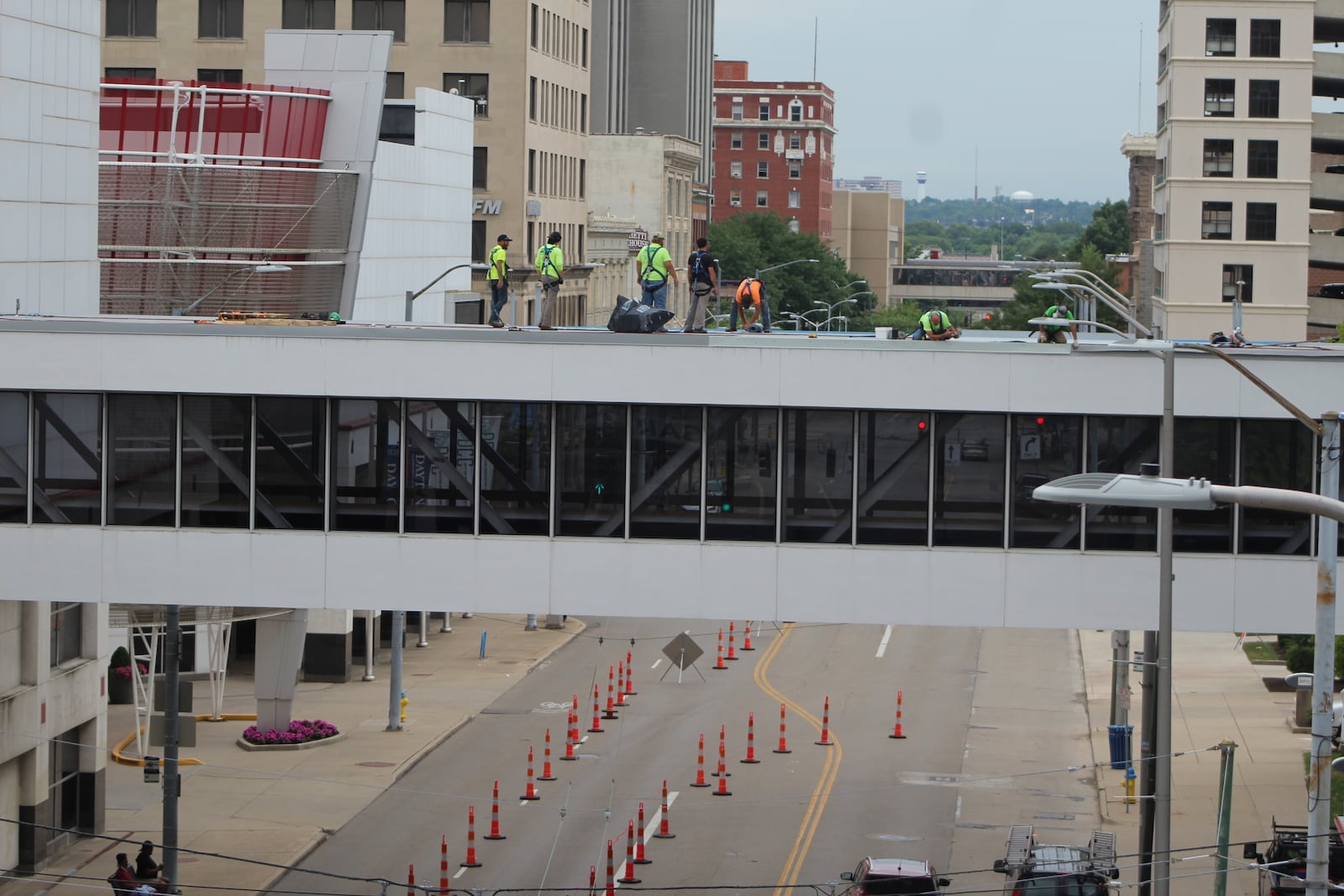 Crews work on the skywalk leading from the Dayton Convention Center to the hotel across the street and the parking garage. CORNELIUS FROLIK / STAFF