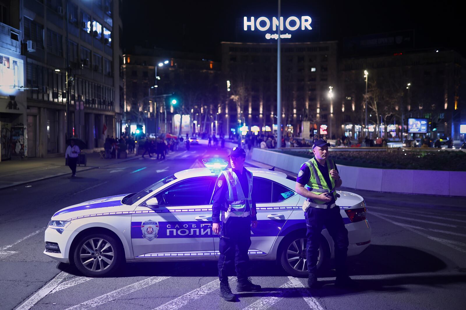 Police officers stand next to their vehicle ahead of a major rally this weekend in downtown Belgrade, Serbia, Friday, March 14, 2025. (AP Photo/Armin Durgut)