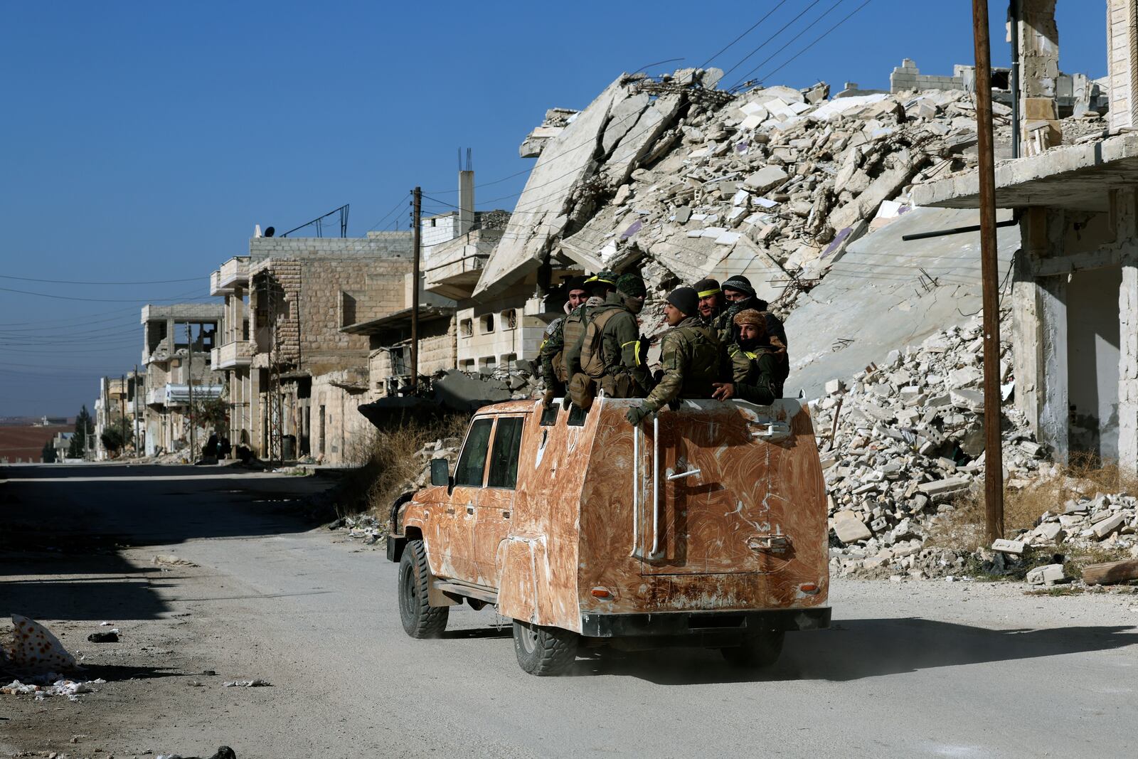 Syrian opposition fighter ride on a truck in Khan Sheikhoun, southwest of Aleppo, Sunday, Dec. 1, 2024. Syrian opposition insurgency launched a campaign on Wednesday with a two-pronged attack on Aleppo and the countryside around Idlib.(AP Photo/Ghaith Alsayed)