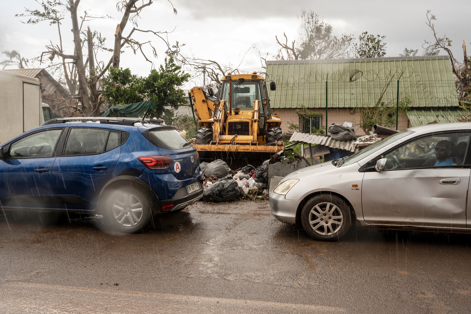 People queue for gas in Mamoudzou in the French Indian Ocean island of Mayotte, Thursday, Dec. 19, 2024, after Cyclone Chido. (AP Photo/Adrienne Surprenant)