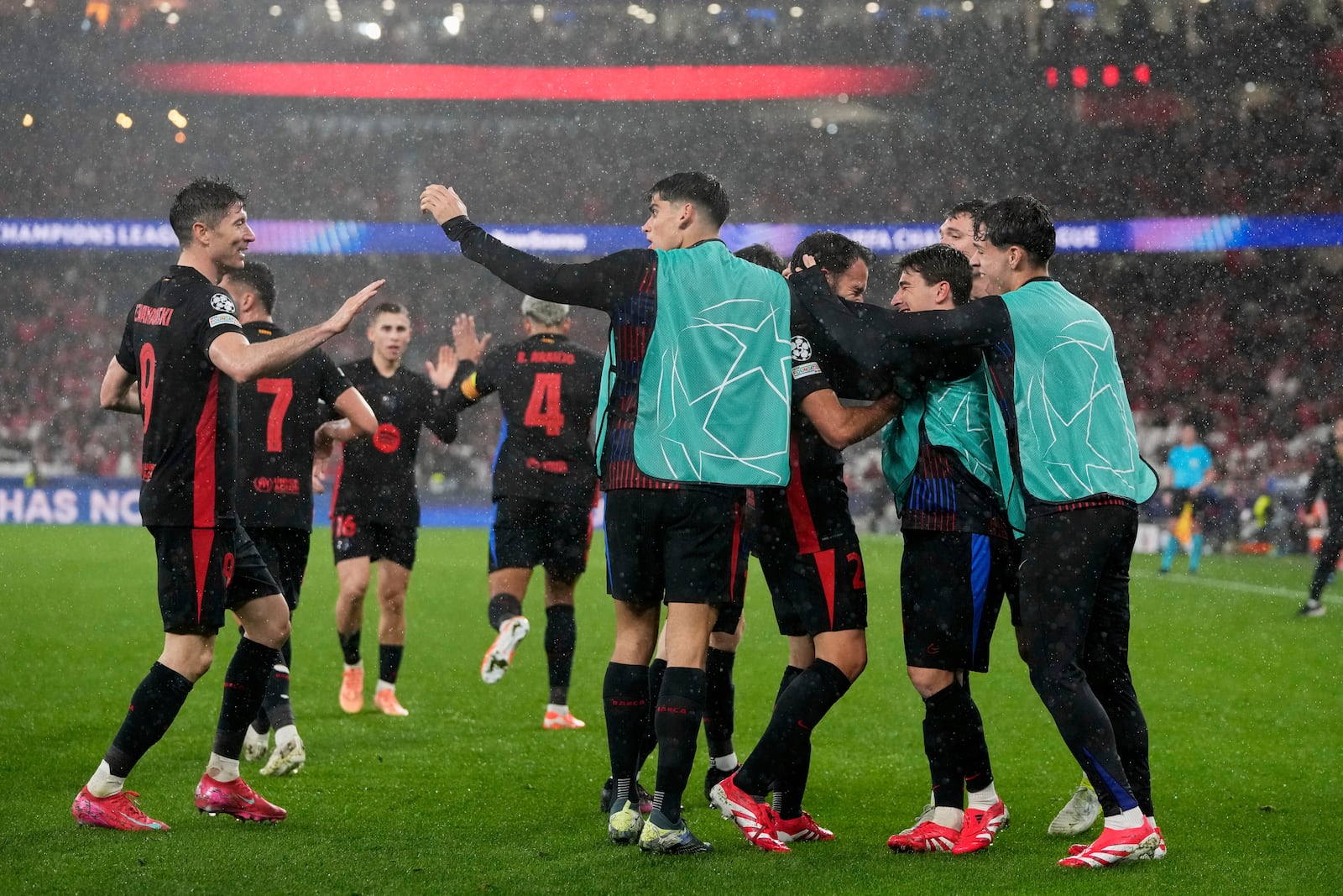 Barcelona celebrate their side's fourth goal during a Champions League opening phase soccer match between SL Benfica and FC Barcelona at the Luz stadium in Lisbon, Tuesday, Jan. 21, 2025. (AP Photo/Armando Franca)