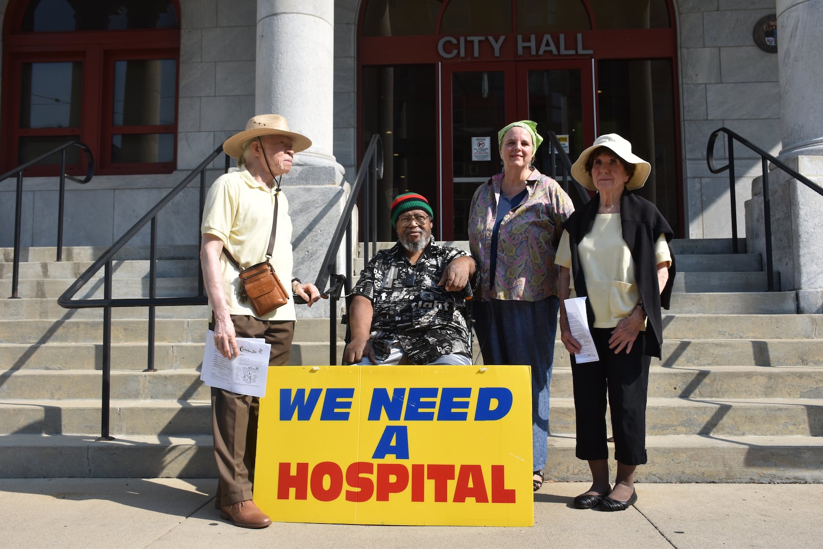 The board of the Clergy Community Coalition gathered outside of Dayton City Hall on Aug. 5, 2024. CORNELIUS FROLIK / STAFF