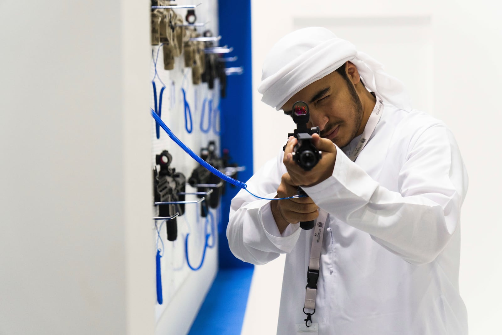 An Emirati man aims with a South Korean-made DSAR-15 rifle at the biennial International Defense Exhibition and Conference arms show in Abu Dhabi, United Arab Emirates, Monday, Feb. 17, 2025. (AP Photo/Jon Gambrell)