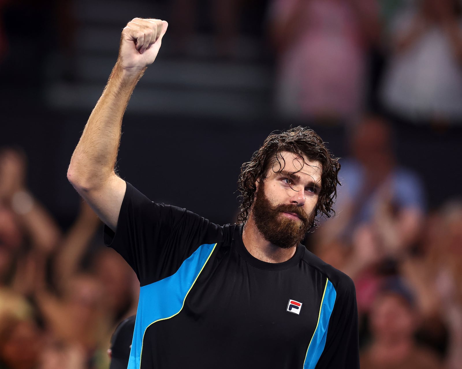 USA's Reilly Opelka celebrates winning his match against Serbia's Novak Djokovic at the Brisbane International, in Brisbane, Australia, Friday, Jan. 3, 2025. (AP Photo/Pat Hoelscher)