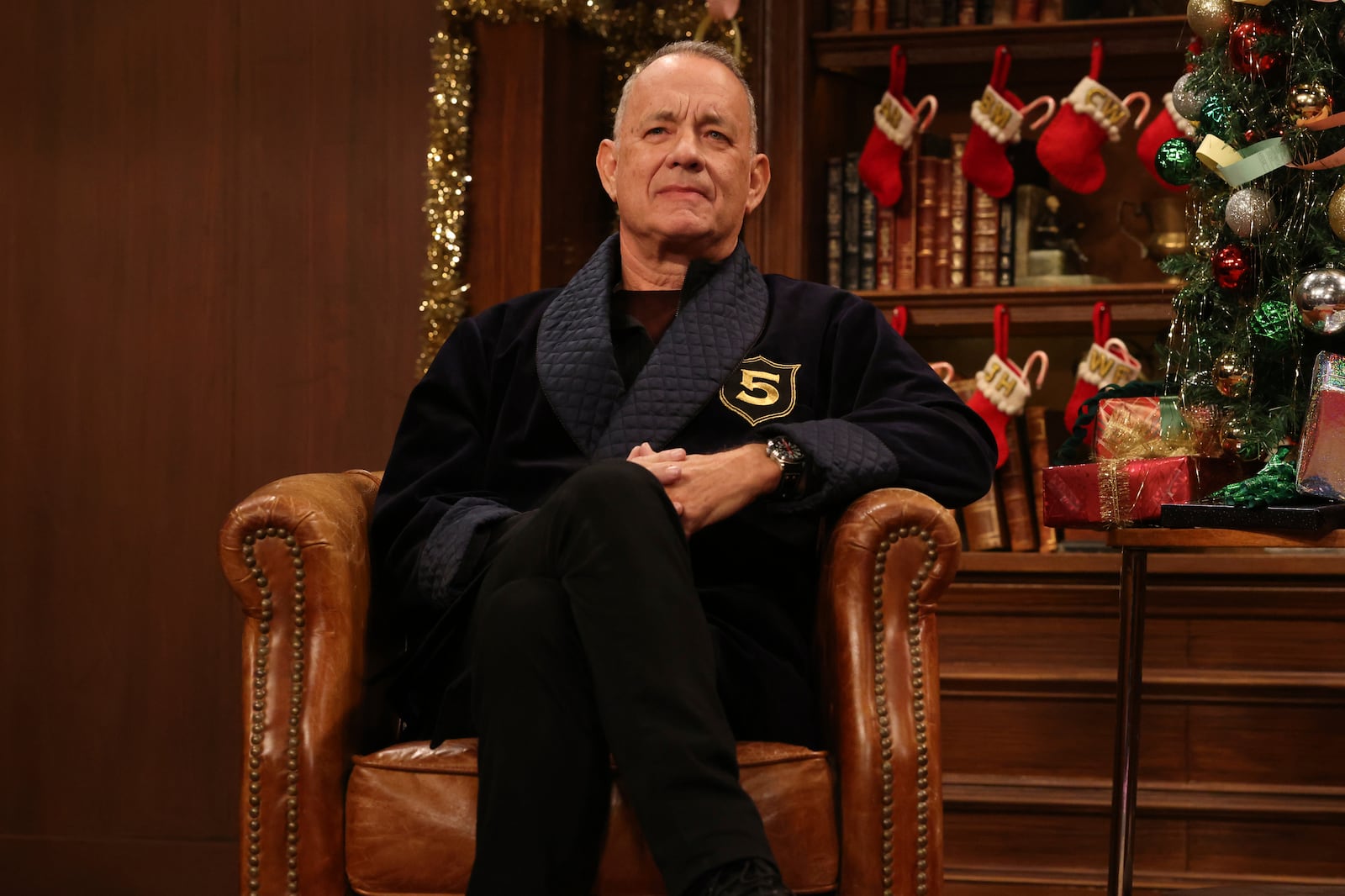 This image released by NBC shows Tom Hanks making a guest appearance during the "5 Timers Club" Cold Open for "Saturday Night Live" on Dec. 21, 2024, in New York. (Will Heath/NBC via AP)