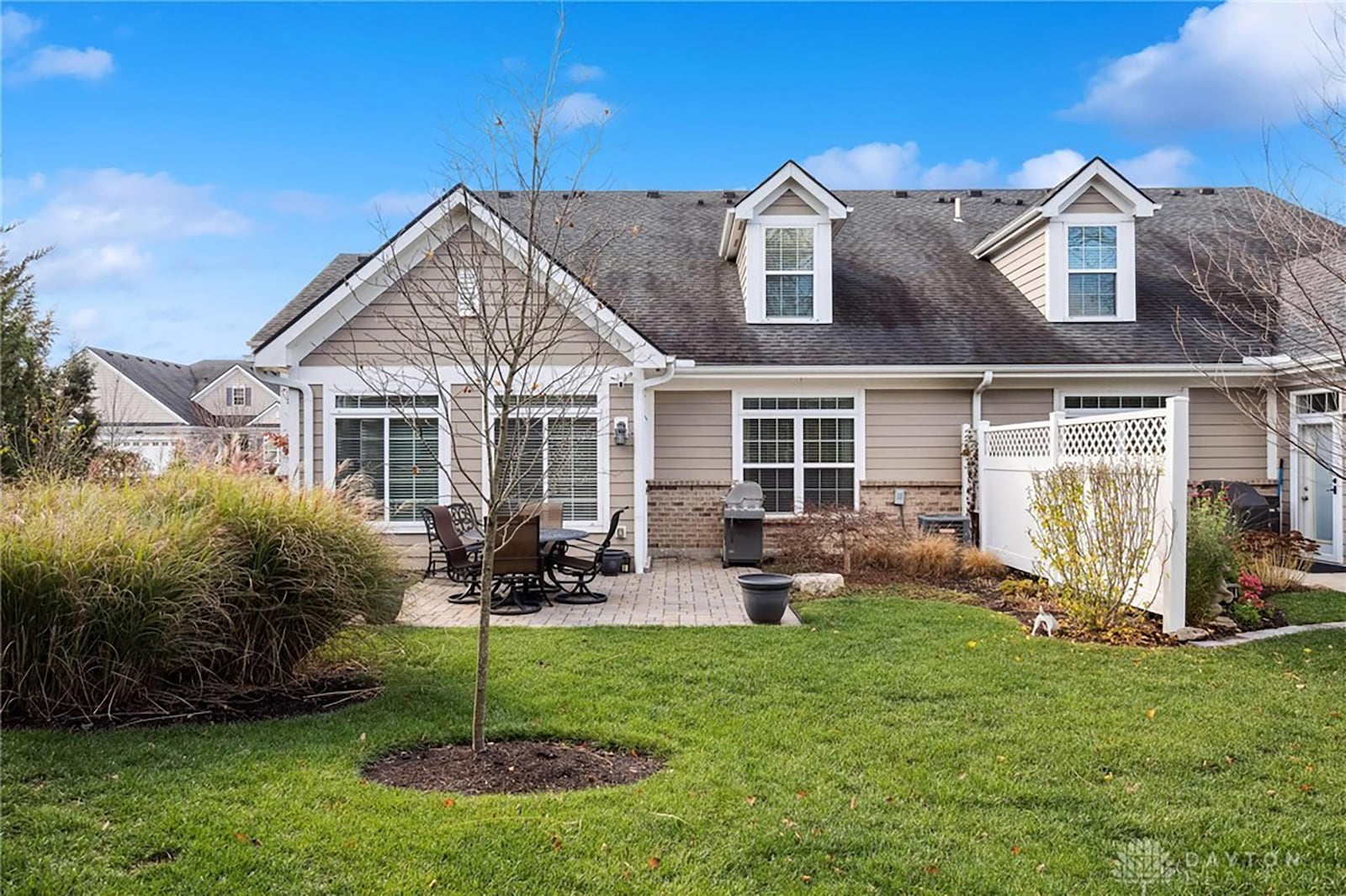 The rear paver patio is private with a vinyl fence between the home and its neighbor.