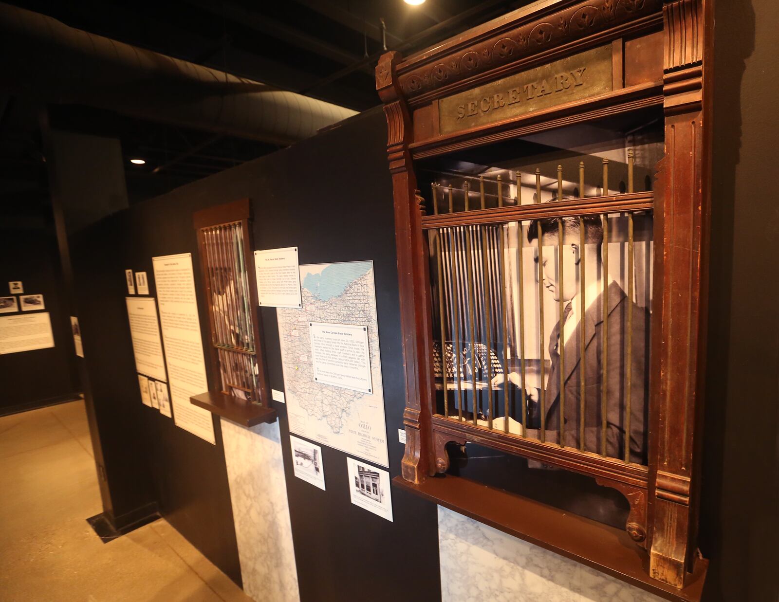 A wooden bank tellers window from the National Bank in New Carlisle that John Dillinger and his gang robbed in 1933 is a tangible piece of history in the Bootleggers, Bandits, and Badges: From Dry Times to Hard Times in Dayton, Ohio, exhibition at Carillon Historical Park. LISA POWELL / STAFF