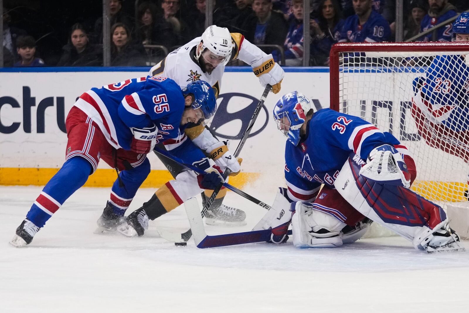 New York Rangers goaltender Jonathan Quick (32) and Ryan Lindgren (55) protect the net from Vegas Golden Knights center Nicolas Roy (10) during the second period of an NHL hockey game Sunday, Feb. 2, 2025, in New York. (AP Photo/Frank Franklin II)