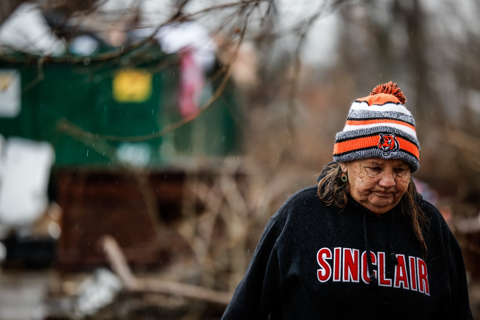 Victoria McNeal walks behind an apartment building on Santa Clara Ave. that has become a dumping ground. JIM NOELKER/STAFF