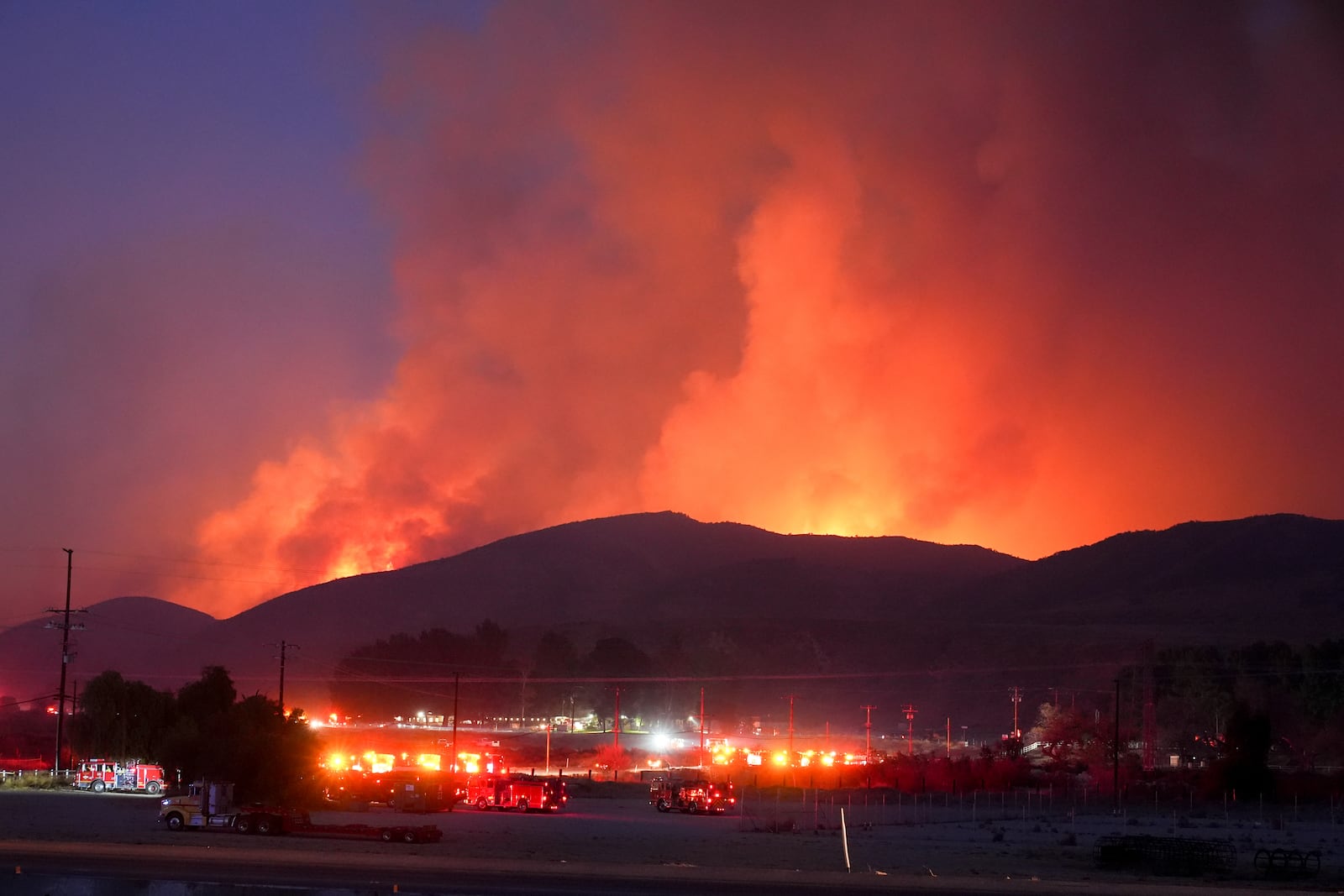 Fire Crews stage under the Hughes Fire Wednesday, Jan. 22, 2025, in Castaic, Calif. (AP Photo/Marcio Jose Sanchez)