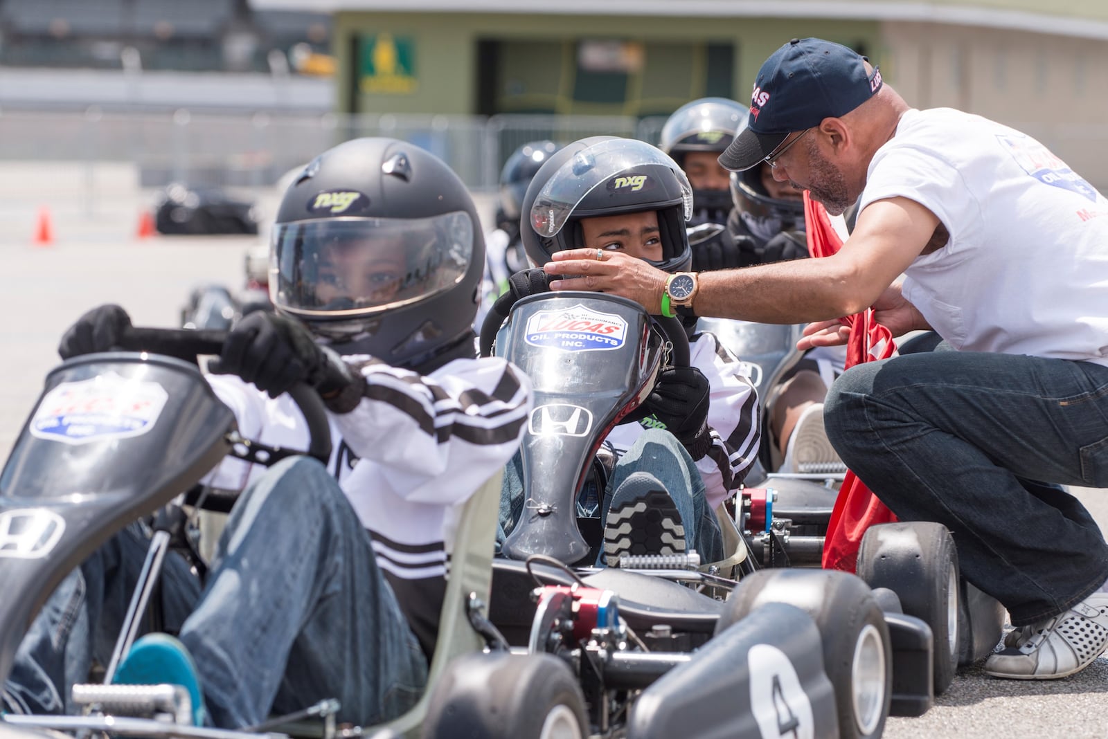 Rod Reid, the President and Chief Instructor of NXG Youth Motorsports, gives instruction to a young go-kart driver.  Reid is also the Team Principal of the Force Indy racing team and he and his drover Myles Rowe – who is the current points leader in the IndyCar sponsored  USF Pro 2000 series – will host a contingent of 50 Dayton kids during race day next Saturday at Indianapolis Motor Speedway. CONTRIBZUTED