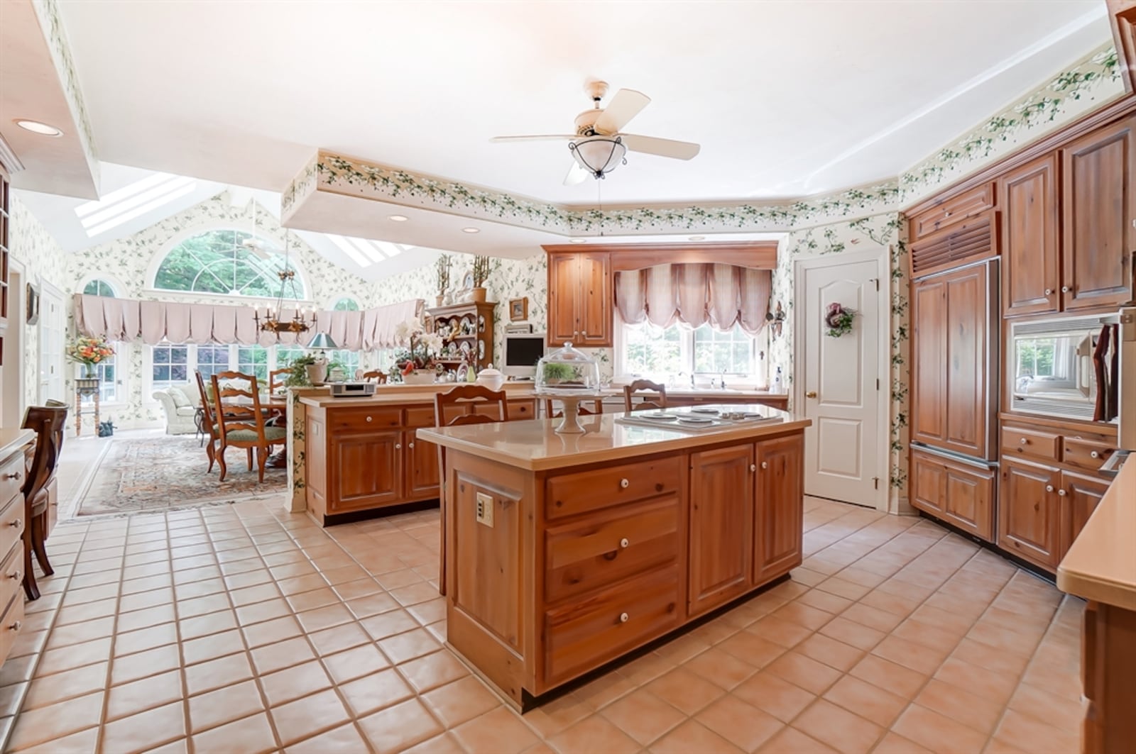 In the kitchen, an island has a cooktop and an extended counter to allow seating. 