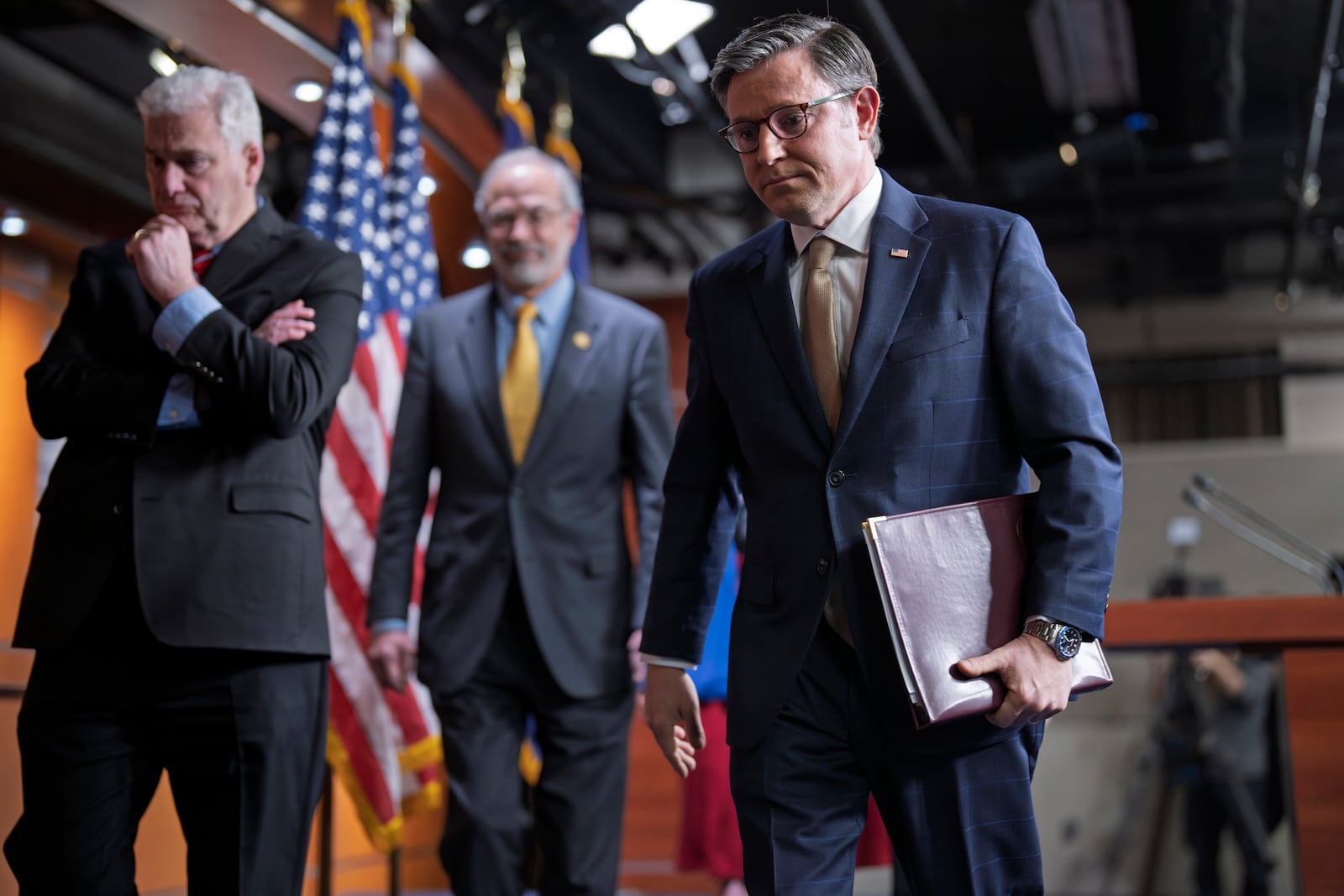 Speaker of the House Mike Johnson, R-La., center, departs a news conference, joined by, from left, Majority Whip Tom Emmer, R-Minn., and Rep. Andy Harris, R-Md., chairman of the House Freedom Caucus, after discussing the interim GOP spending bill that would keep federal agencies funded through Sept. 30, at the Capitol, in Washington, Tuesday, March 11, 2025. (AP Photo/J. Scott Applewhite)