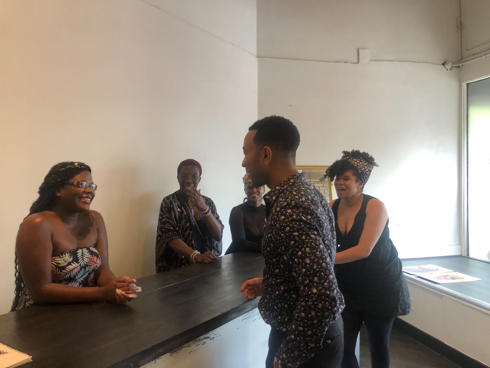 John Legend makes a stop at Puff Apothecary in the Oregon District on Sunday, Aug. 11, one week after the mass shooting that killed nine people and injured 27 others. AMELIA ROBINSON/STAFF