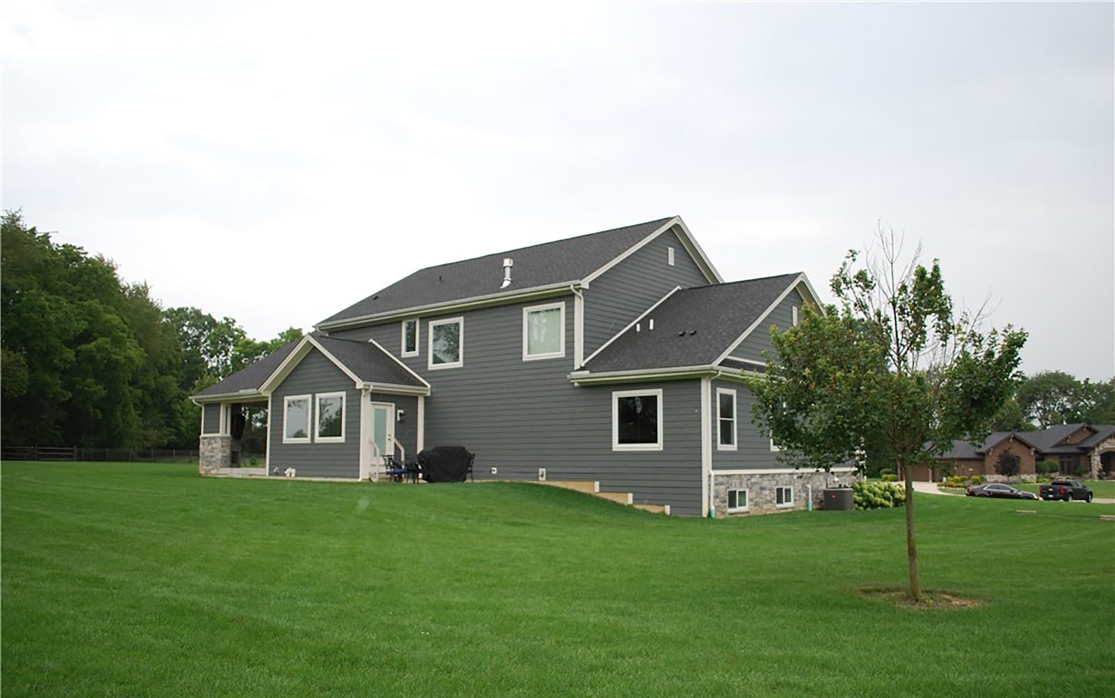 The back of the home features a covered porch with fireplace