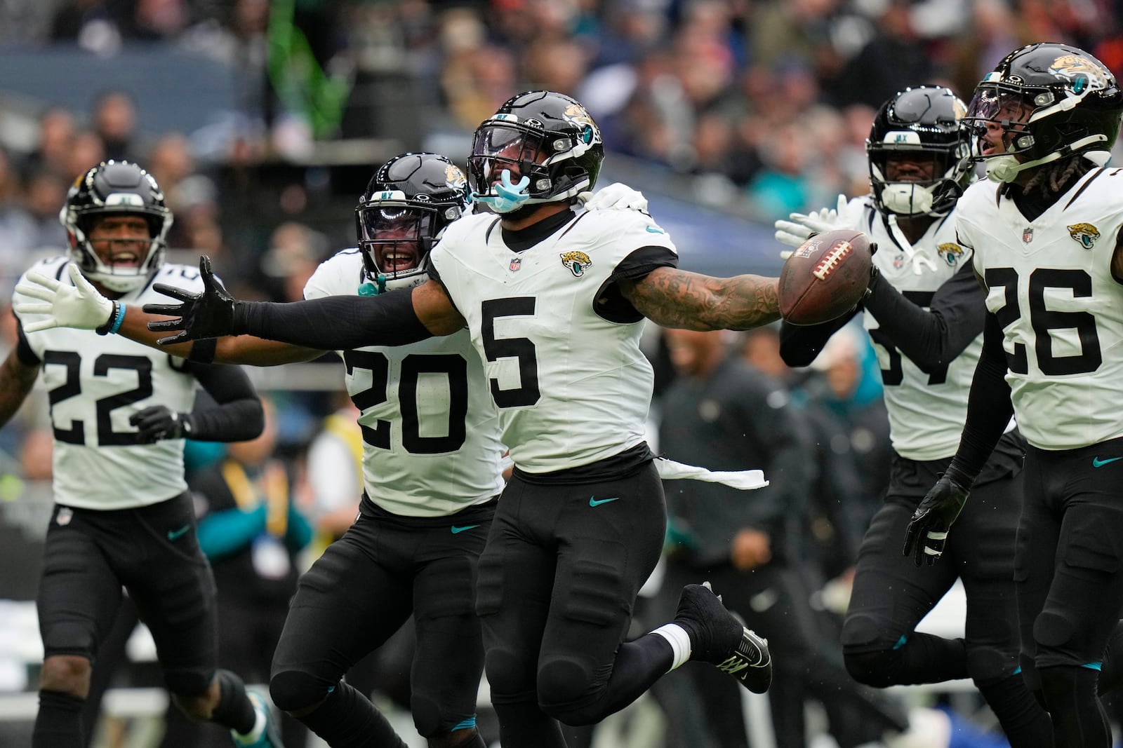 Jacksonville Jaguars safety Andre Cisco (5) celebrates making an interception during an NFL football game at the Tottenham Hotspur stadium between the Jacksonville Jaguars and Chicago Bears in London, Sunday, Oct. 13, 2024. (AP Photo/Steve Luciano)