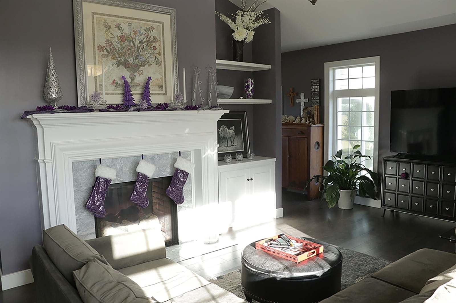 A dual-sided gas fireplace divides the great room from the combination kitchen and dining area. On the great room side, the fireplace is more elegant with marble surround and detailed wood mantel. Next to the fireplace is a built-in display nook with open shelves and cabinetry. CONTRIBUTED PHOTO BY KATHY TYLER