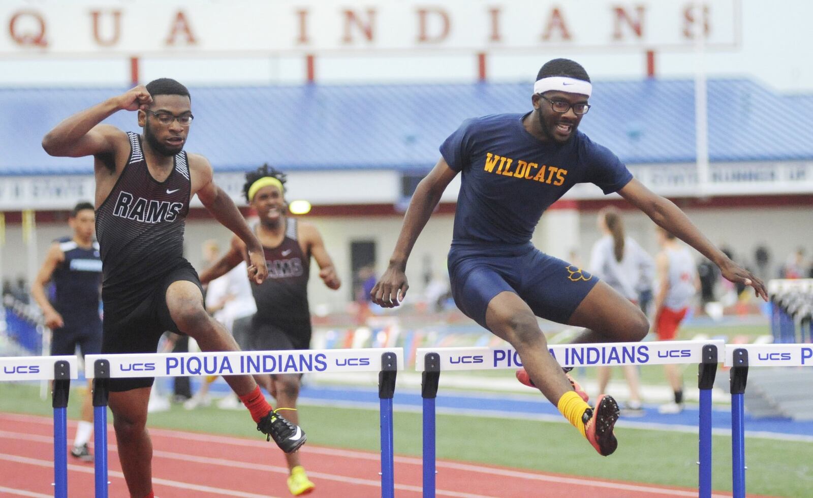 Springfield’s Austin Tyree (right) beats Joshua Byars-Mason of Trotwood-Madison to win the 300 hurdles in the D-I district track and field meet at Piqua on Friday, May 18, 2018. MARC PENDLETON / STAFF