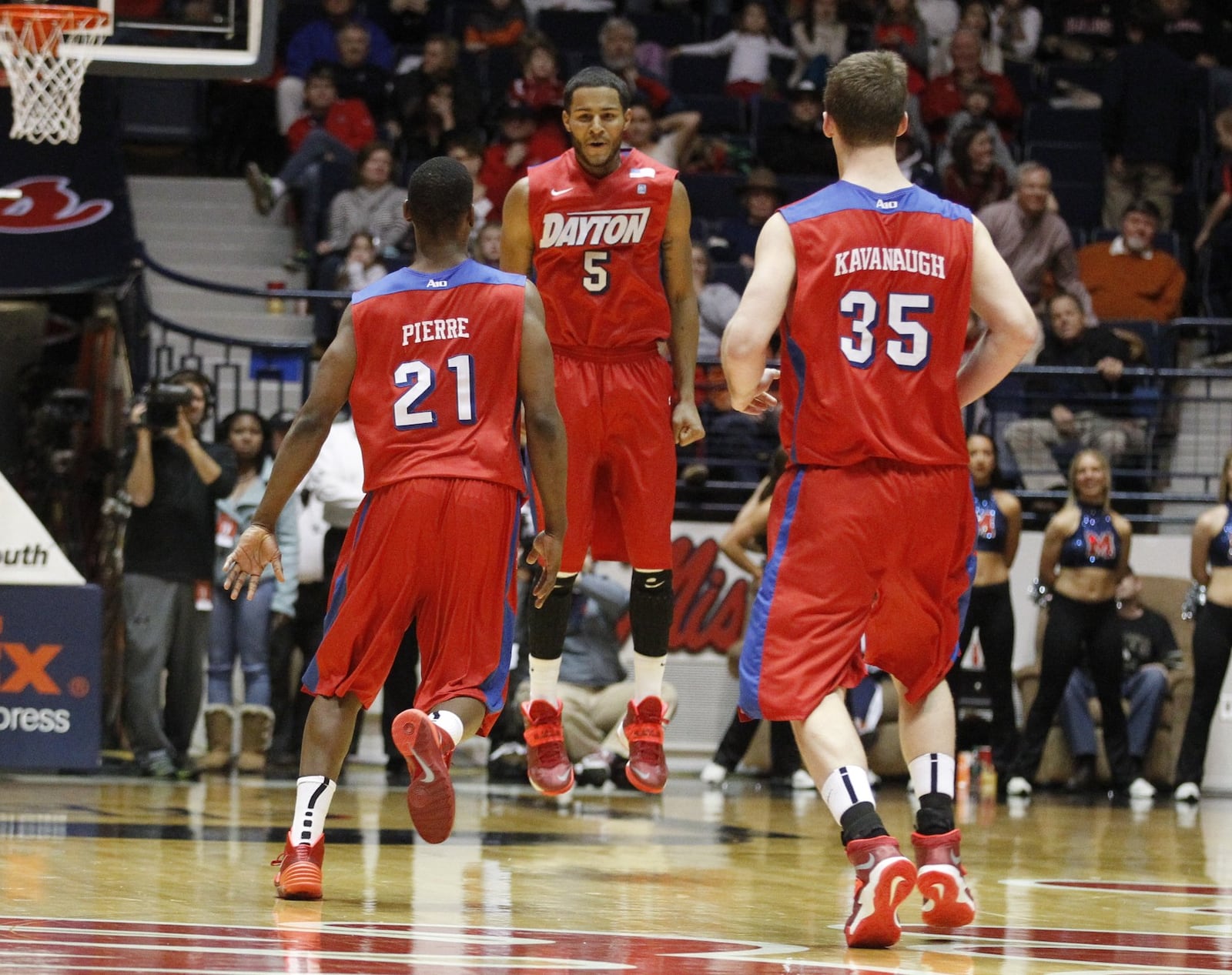 Dayton forward Devin Oliver, center, celebrates with Jordan Sibert, left, and Matt Kavanaugh after his game-winning 3-pointer against Ole Miss with 0.3 to play in overtime on Saturday, Jan. 4, 2014, in Oxford, Miss. David Jablonski/Staff