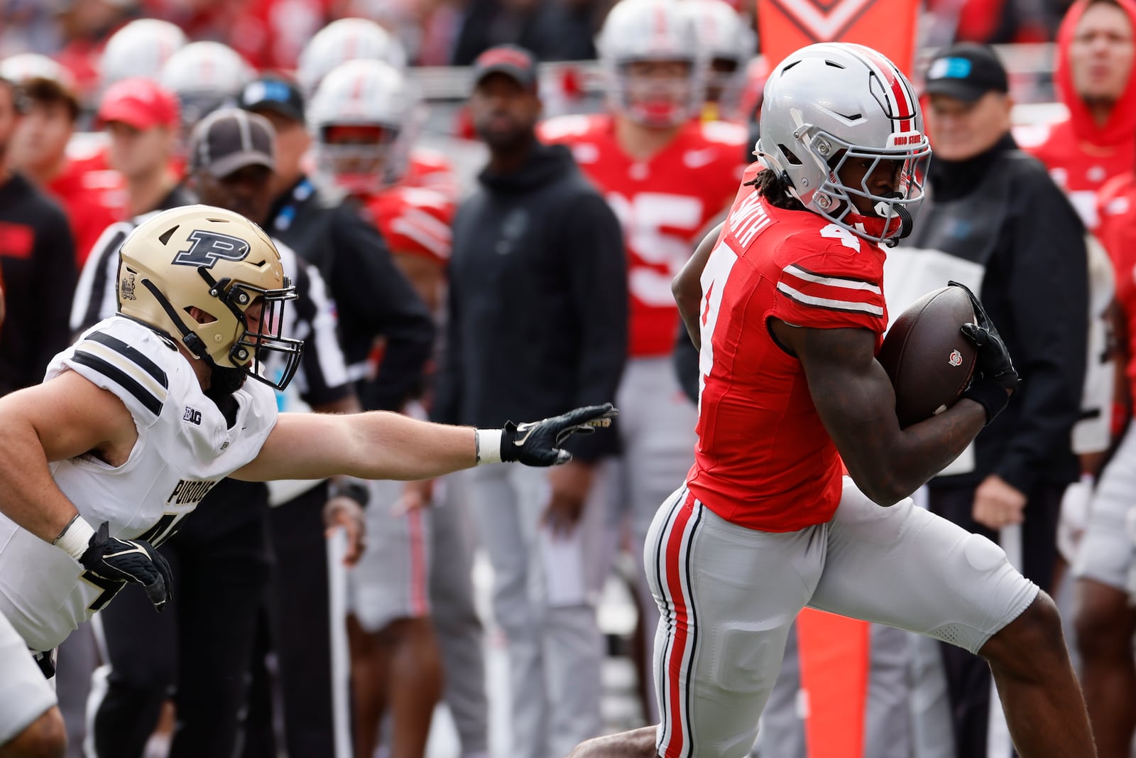 Ohio State receiver Jeremiah Smith, right, is forced out of bounds by Purdue linebacker Hudson Miller during the first half of an NCAA college football game Saturday, Nov. 9, 2024, in Columbus, Ohio. (AP Photo/Jay LaPrete)