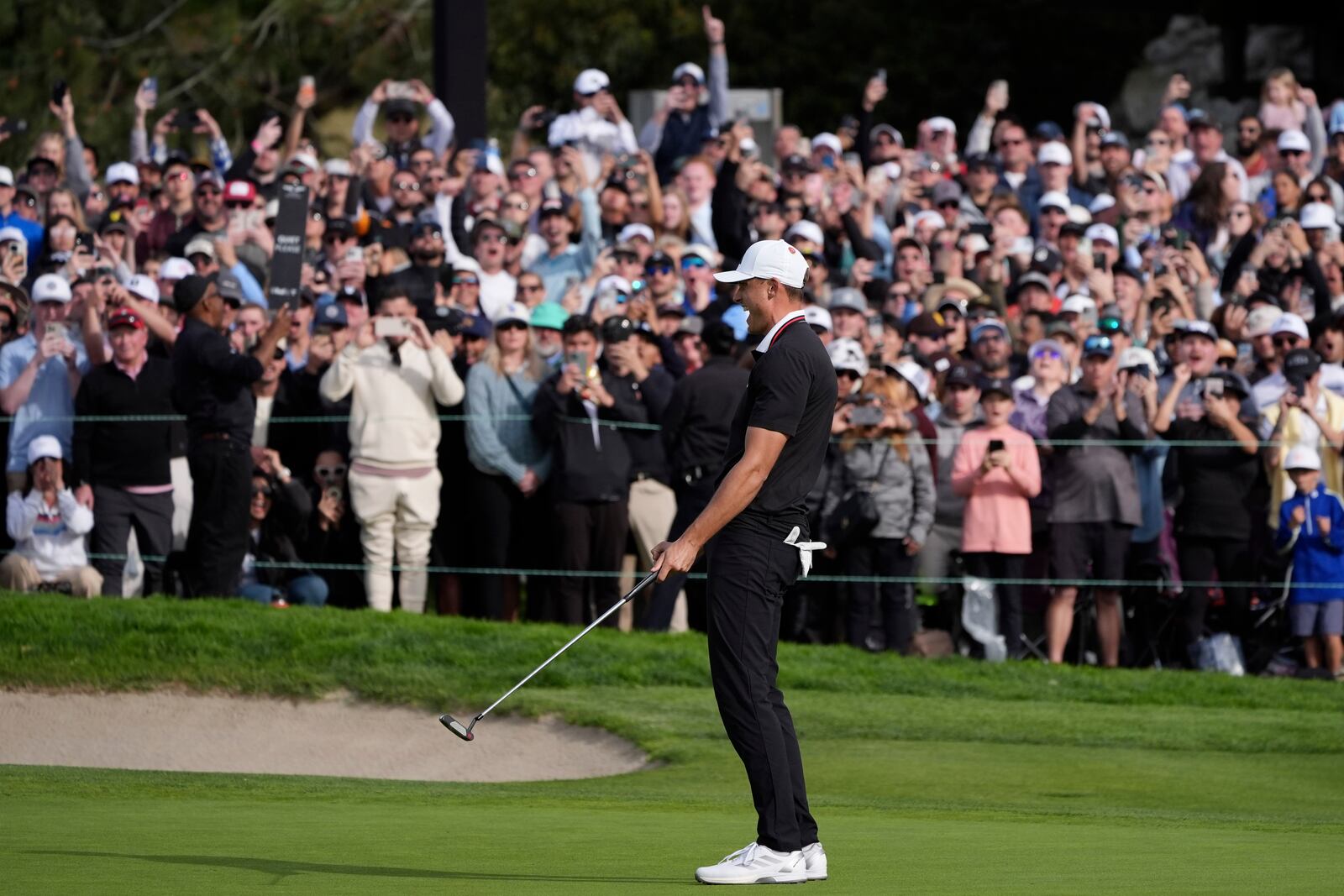 Ludvig Åberg, of Sweden, celebrates after making a birdie putt on the 18th green of the South Course at Torrey Pines during the final round of the Genesis Invitational golf tournament Sunday, Feb. 16, 2025, in San Diego. (AP Photo/Gregory Bull)