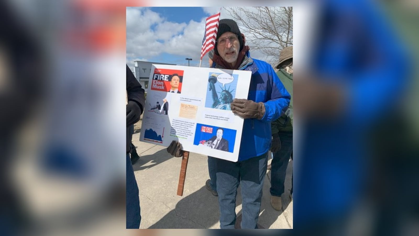 Hundreds of people lined West Dorothy Lane in Moraine on Saturday, March 1, 2025 to protest near a Tesla Service Center, including Rich Cohen (pictured). The protest was aimed at Elon Musk, the world's richest man, and his actions with the Trump administration and the Department of Government Efficiency. BROOKE SPURLOCK/STAFF