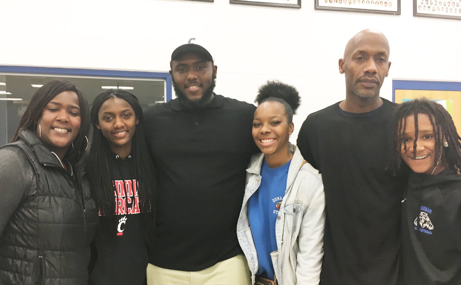 Dunbar High School senior Jonathan Allen (middle) is surrounded by family and friends at the school after signing to play football at the University of Cincinnati on Wednesday, Feb. 6, 2019. MARC PENDLETON / STAFF