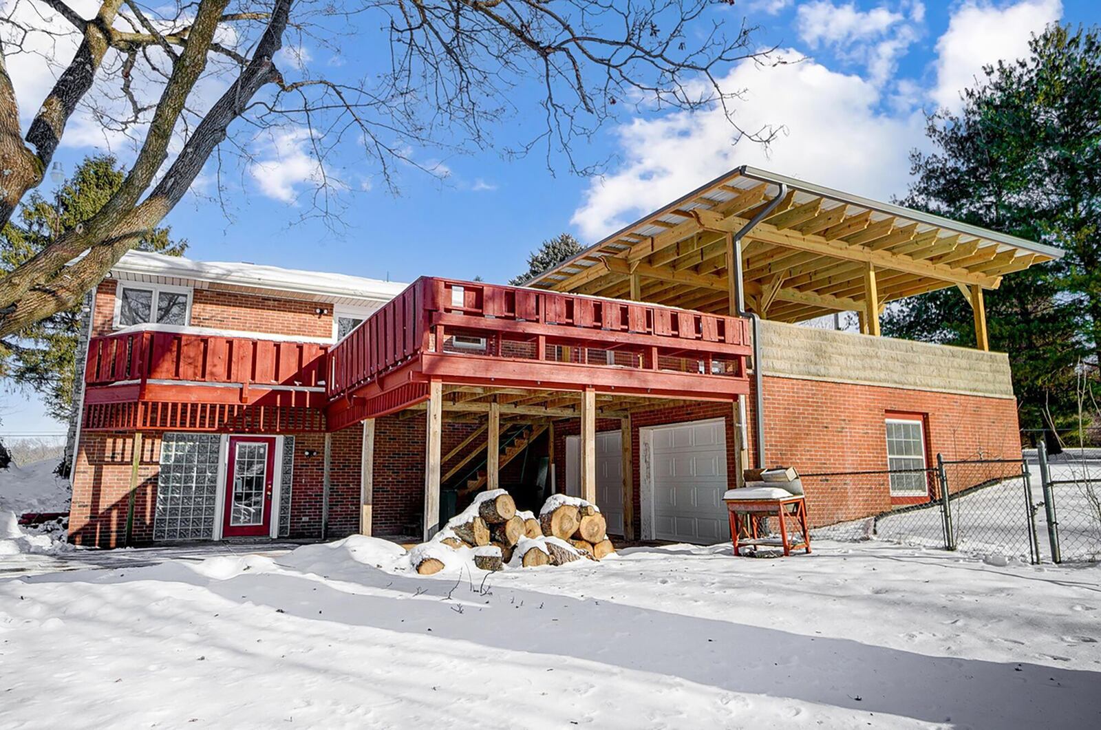 The rear of the home has a walk out basement, wood deck and covered patio off the primary suite.