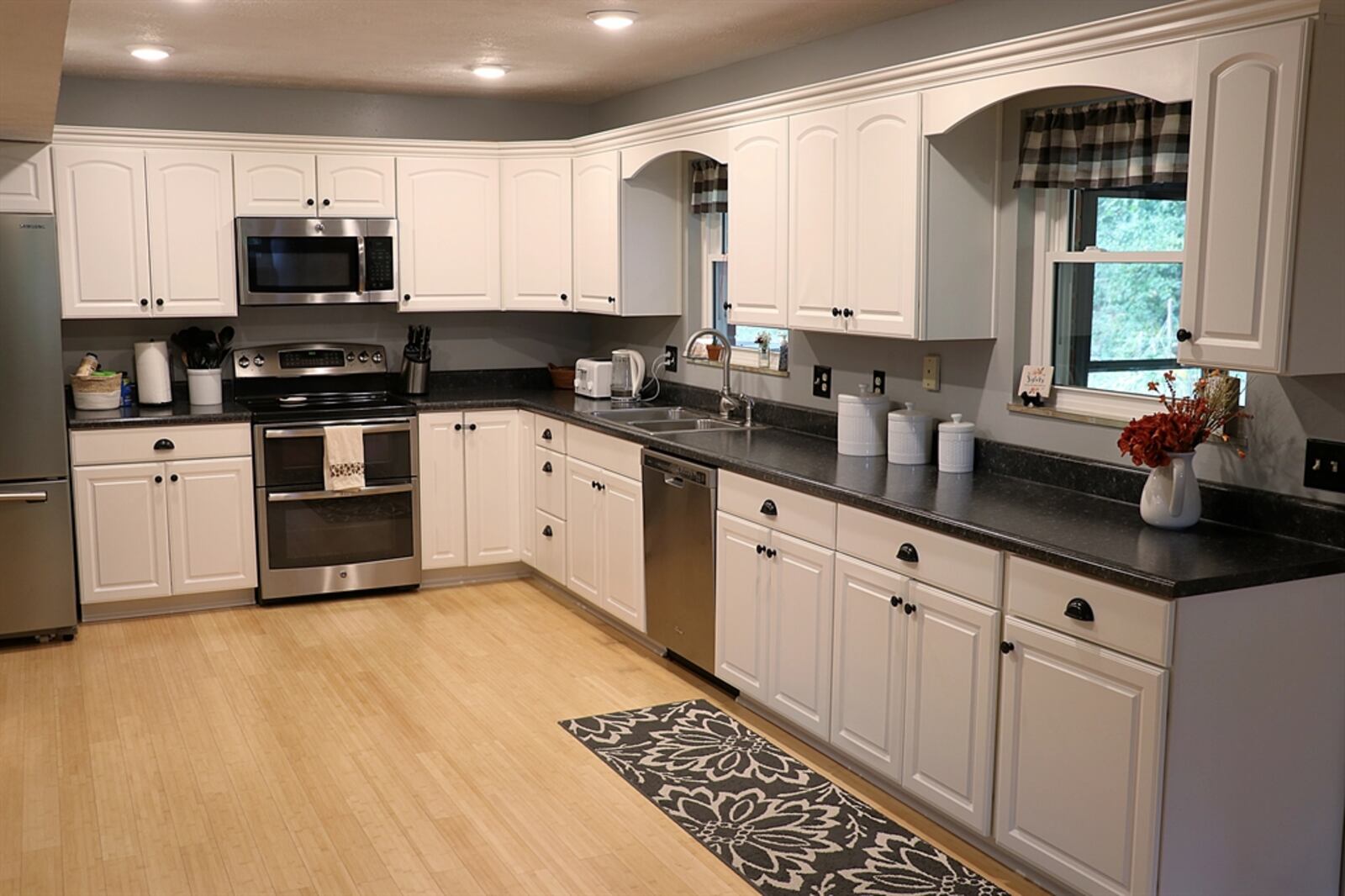 The kitchen is has white cabinets and stainless-steel appliances. KATHY TYLER/CONTRIBUTOR