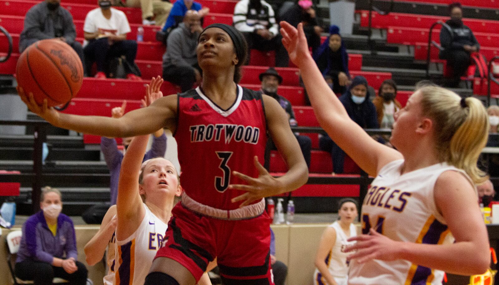 Trotwood-Madison freshman Raeven Raye-Redmond puts up a shot in front of Eaton's Olivia Baumann. Trotwood rallied from 17 down to win 68-67 on Monday night at Tecumseh High School. Jeff Gilbert/CONTRIBUTED