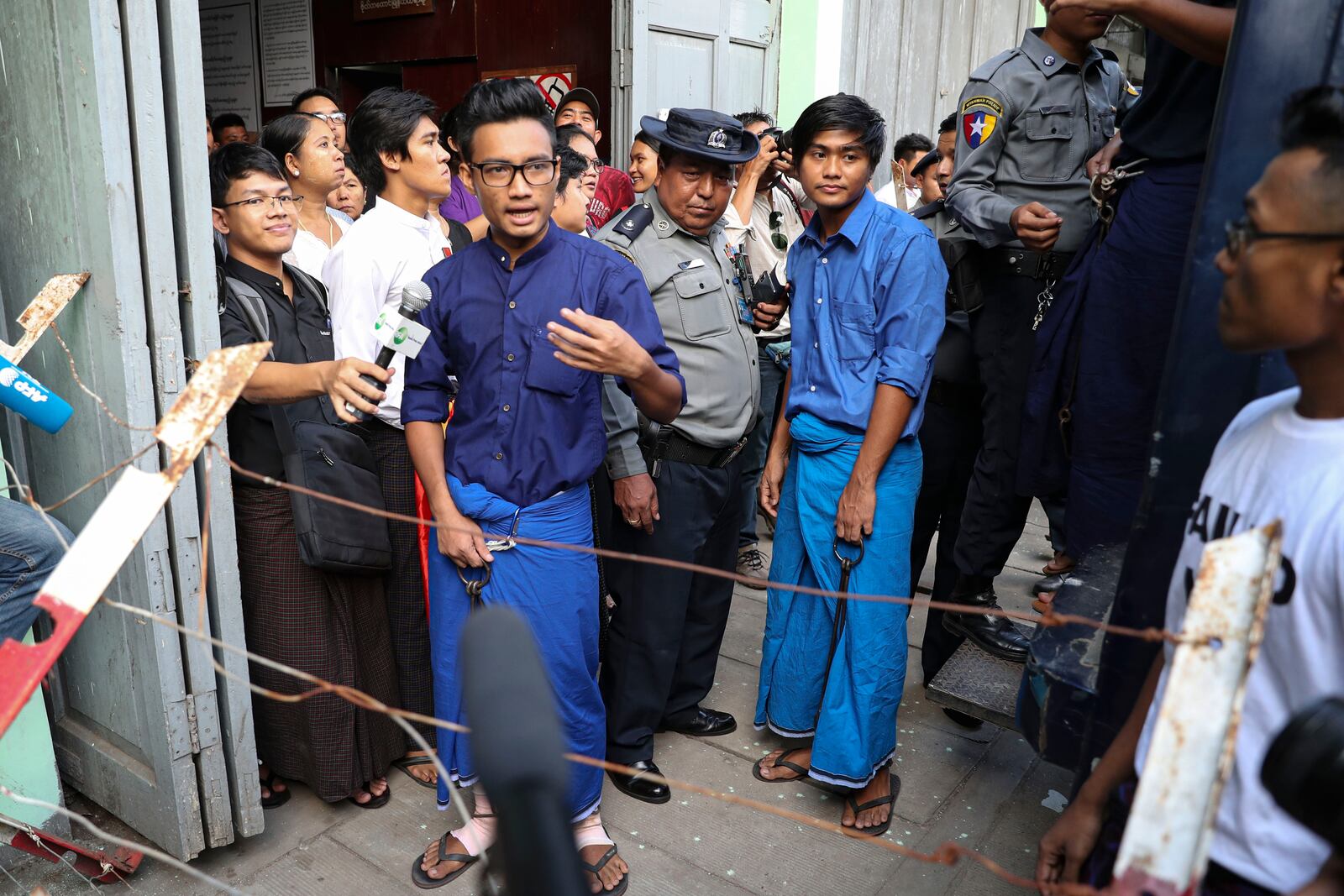 FILE - Paing Phyo Min, member of Student Union and a leader of Peacock Generation "Thangyat" Performance Group, talks to journalists as he leaves a township court along with his colleague, Zayar Lwin, right, after their trial, in Yangon, Myanmar, April 27, 2019. (AP Photo/Thein Zaw, File)