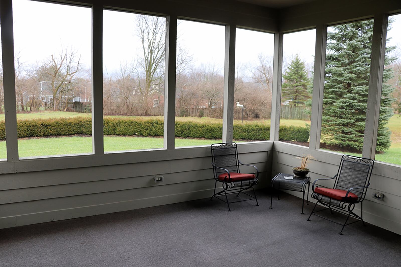 A glass door opens from the breakfast room to a screen-enclosed porch that has views of the semi-private, near-acre property. CONTRIBUTED PHOTO BY KATHY TYLER