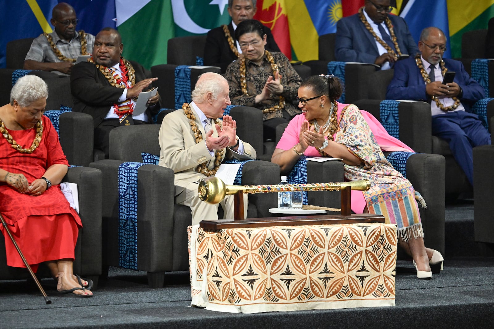 CHOGM Secretary General Patricia Scotland, right, talks to Britain's King Charles III, center, during the opening ceremony for the Commonwealth Heads of Government Meeting (CHOGM) in Apia, Samoa, on Friday, Oct. 25, 2024. (AP Photo/William West, Pool)