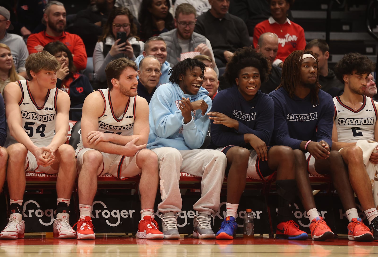 Dayton players on the bench, including Malachi Smith and Marvel Allen, center, laugh during a game against George Washington on Tuesday, Jan. 30, 2024, at UD Arena. David Jablonski/Staff