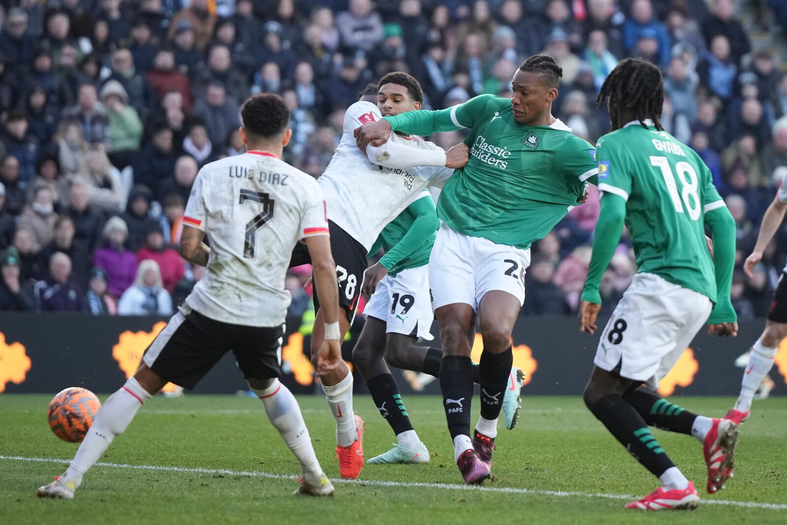 Liverpool's Jarell Quansah, left, challenges for the ball with Plymouth Argyle's Muhamed Tijani during the English FA Cup fourth round soccer match between Plymouth Argyle and Liverpool at Home Park stadium in Plymouth, England, Sunday, Feb. 9, 2025. (AP Photo/Alastair Grant)