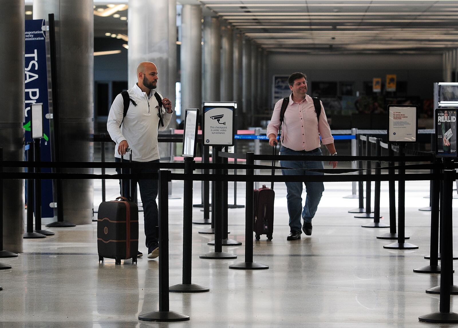 Travelers walk through Dayton International Airport Thursday, June 27, 2024. The airport will be busy for Independence Day week as travel nationwide is expected to be 5% greater than in 2023 and 8% greater than 2019. MARSHALL GORBY/STAFF