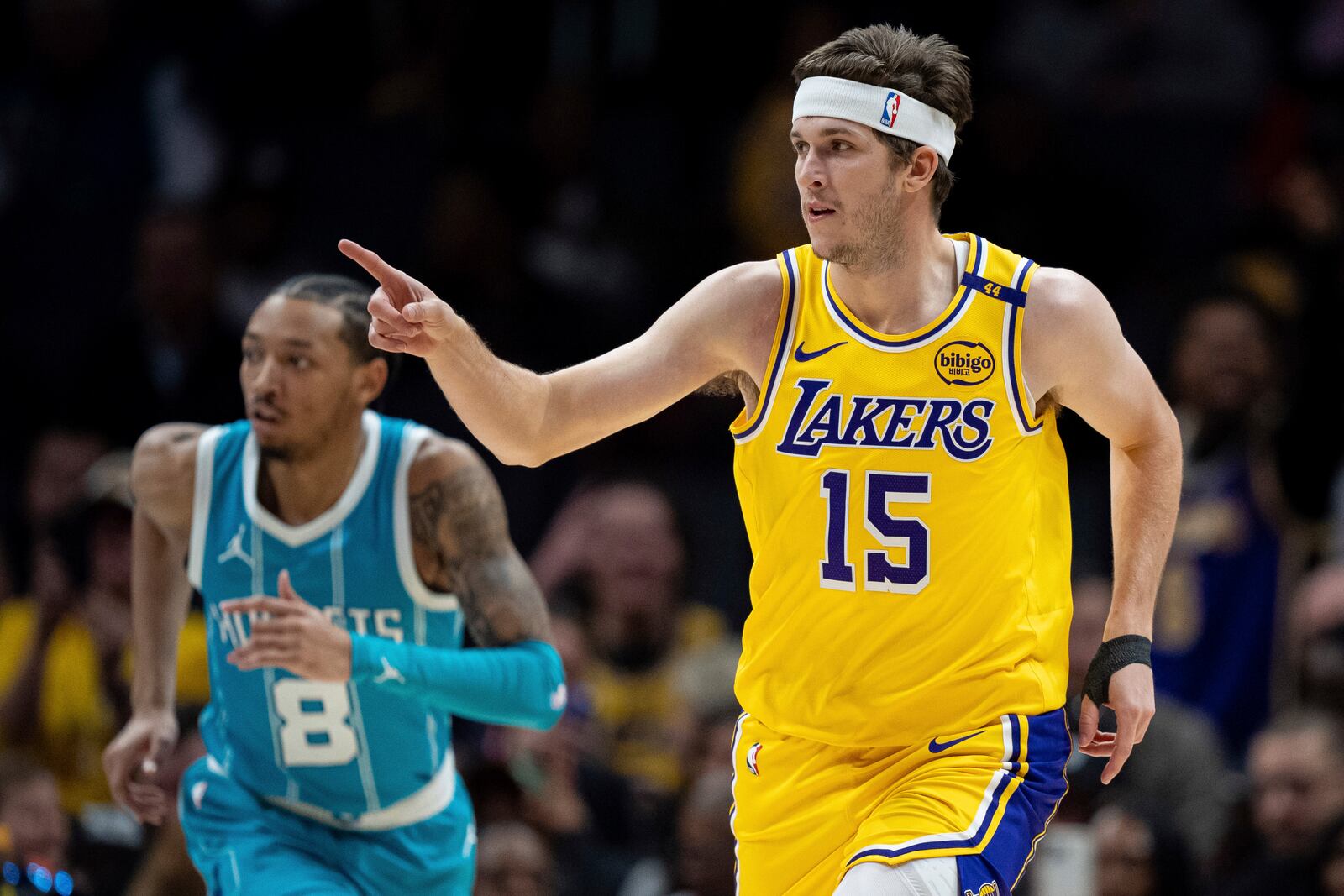 Los Angeles Lakers guard Austin Reaves (15) reacts after making a basket during the first half of an NBA basketball game against the Charlotte Hornets, Monday, Jan. 27, 2025, in Charlotte, N.C. (AP Photo/Jacob Kupferman)