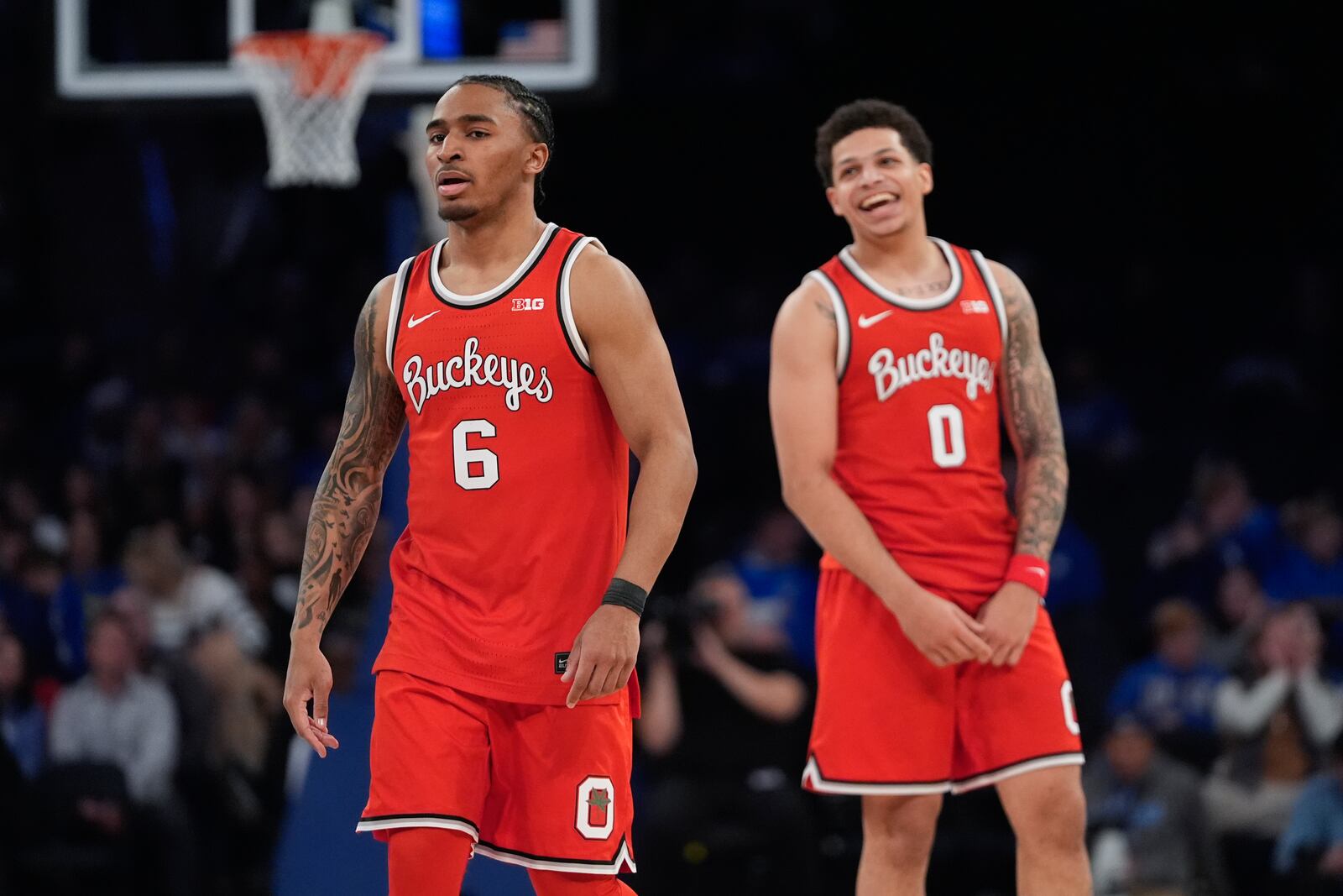 Ohio State's Ques Glover (6) and John Mobley Jr. (0) celebrate during the second half of an NCAA college basketball game against Kentucky in the CBS Sports Classic, Saturday, Dec. 21, 2024, in New York. (AP Photo/Frank Franklin II)