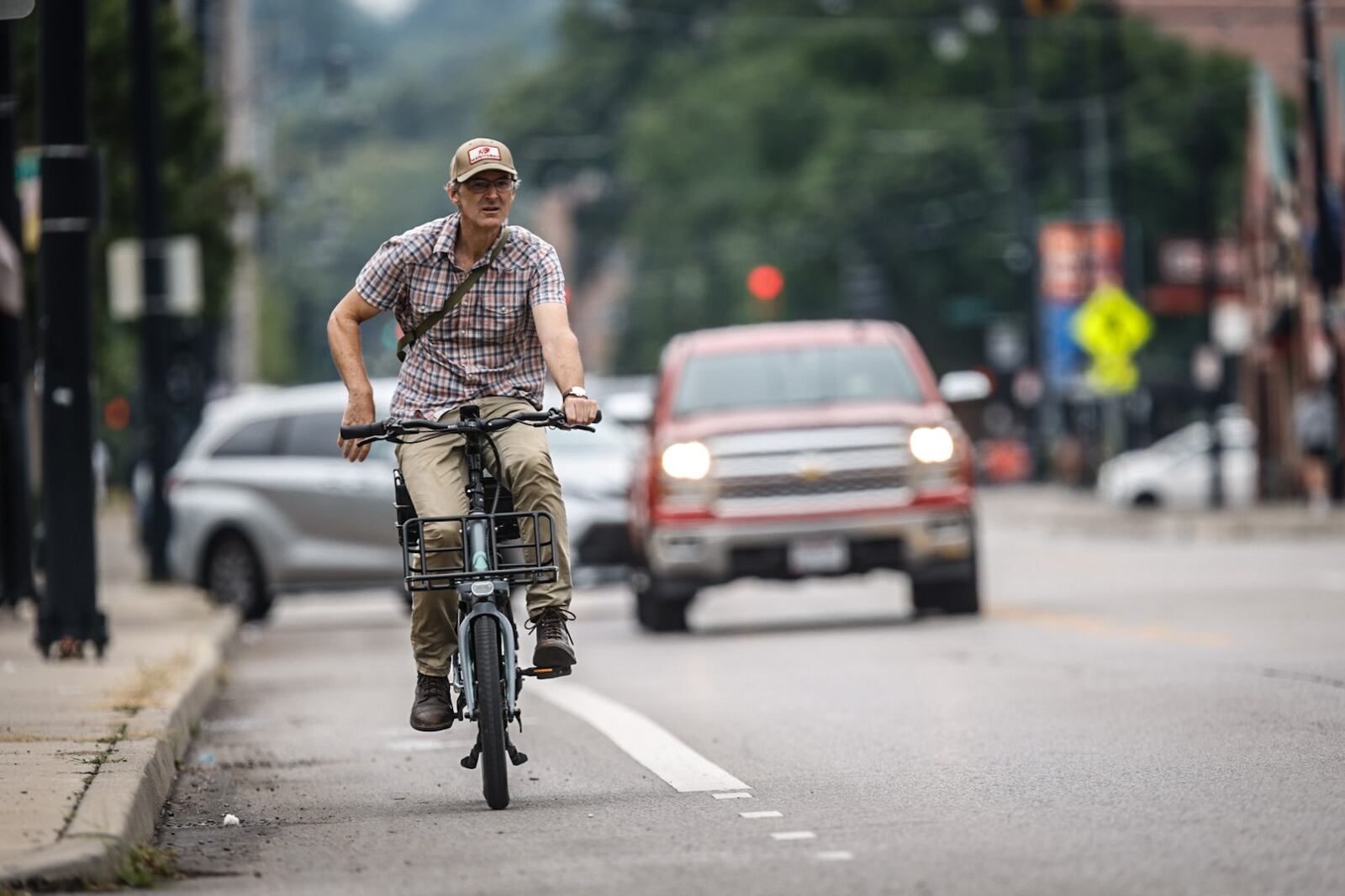 Jason Majerski, from South Park, rides his bike up Brown Street in Dayton Monday August 14, 2023. The city of Dayton is finalizing a plan to improve ways people get around the city without cars. JIM NOELKER/STAFF