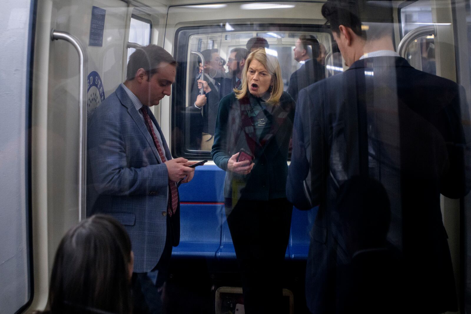 Sen. Lisa Murkowski, R-Alaska, right, talks with Sen. Katie Britt, R-Ala., left, as they ride the Senate subway at the Capitol, Thursday, Jan. 23, 2025, in Washington. (AP Photo/Rod Lamkey, Jr.)